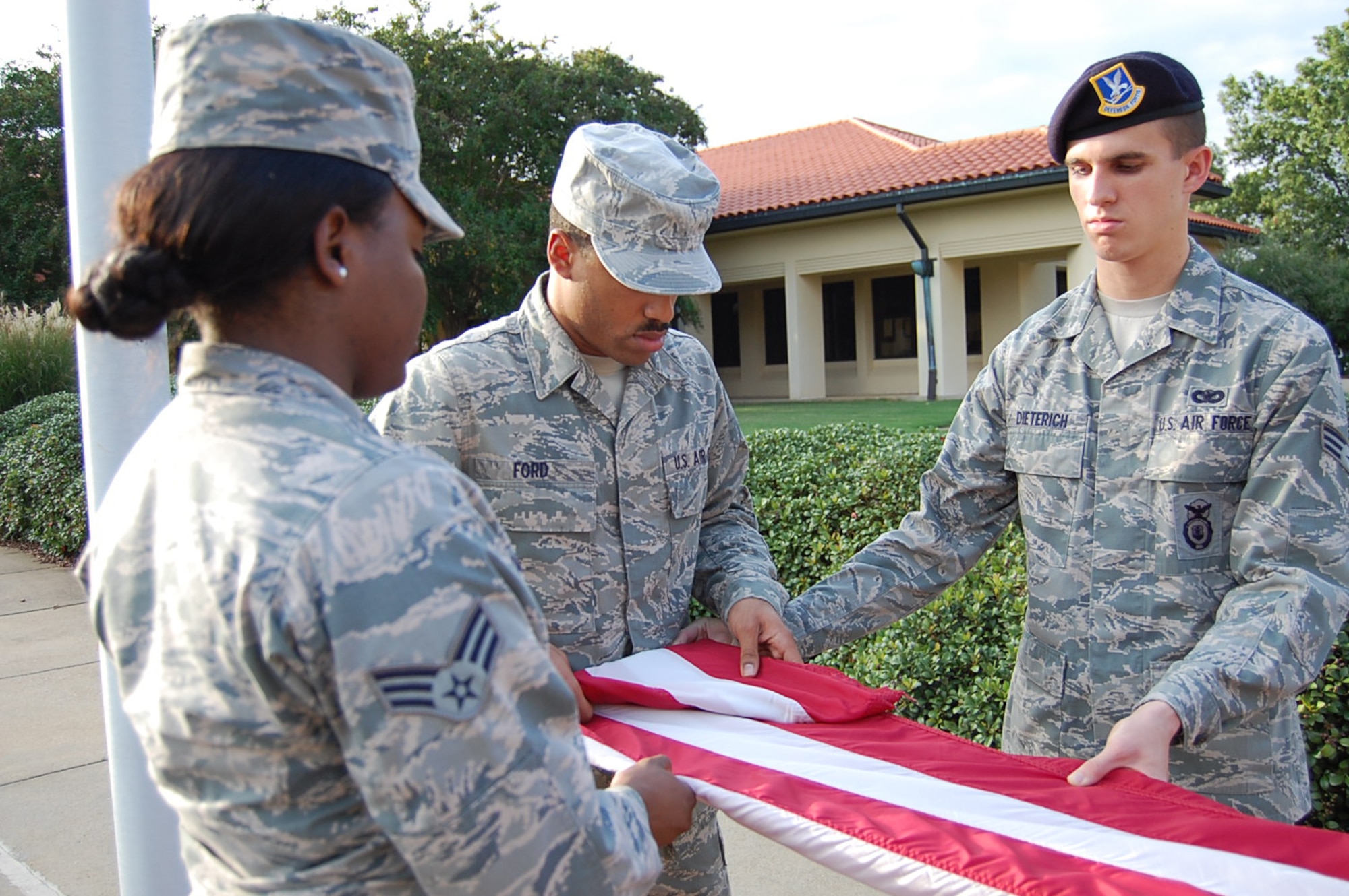 Maxwell Air Force Base Airman Leadership School class 13-7 folds the flag while conducting retreat, Oct. 3. Despite budgetary constraints, ALS is continuing here throughout the government shutdown. (Courtesy photo)