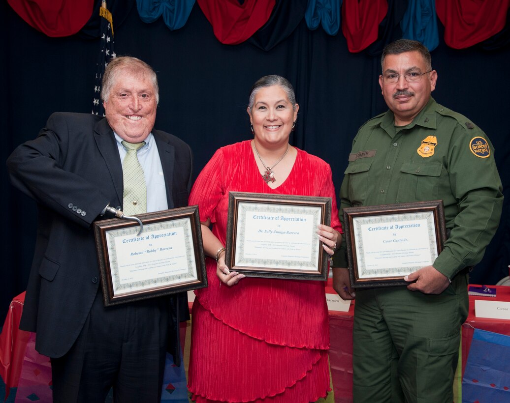 From left to right, Roberto Barrera, Dr. Sally Zuniga-Barrera and Cesar Cantu Jr., hold their certificates of appreciation for being speakers at the Brown Bag Luncheon at Laughlin Air Force Base, Texas, Oct. 2, 2013. The luncheon was one of the events on Laughlin to recognize and celebrate Nation Hispanic Heritage Month. (U.S. Air Force photo/Airman 1st Class Jimmie D. Pike)