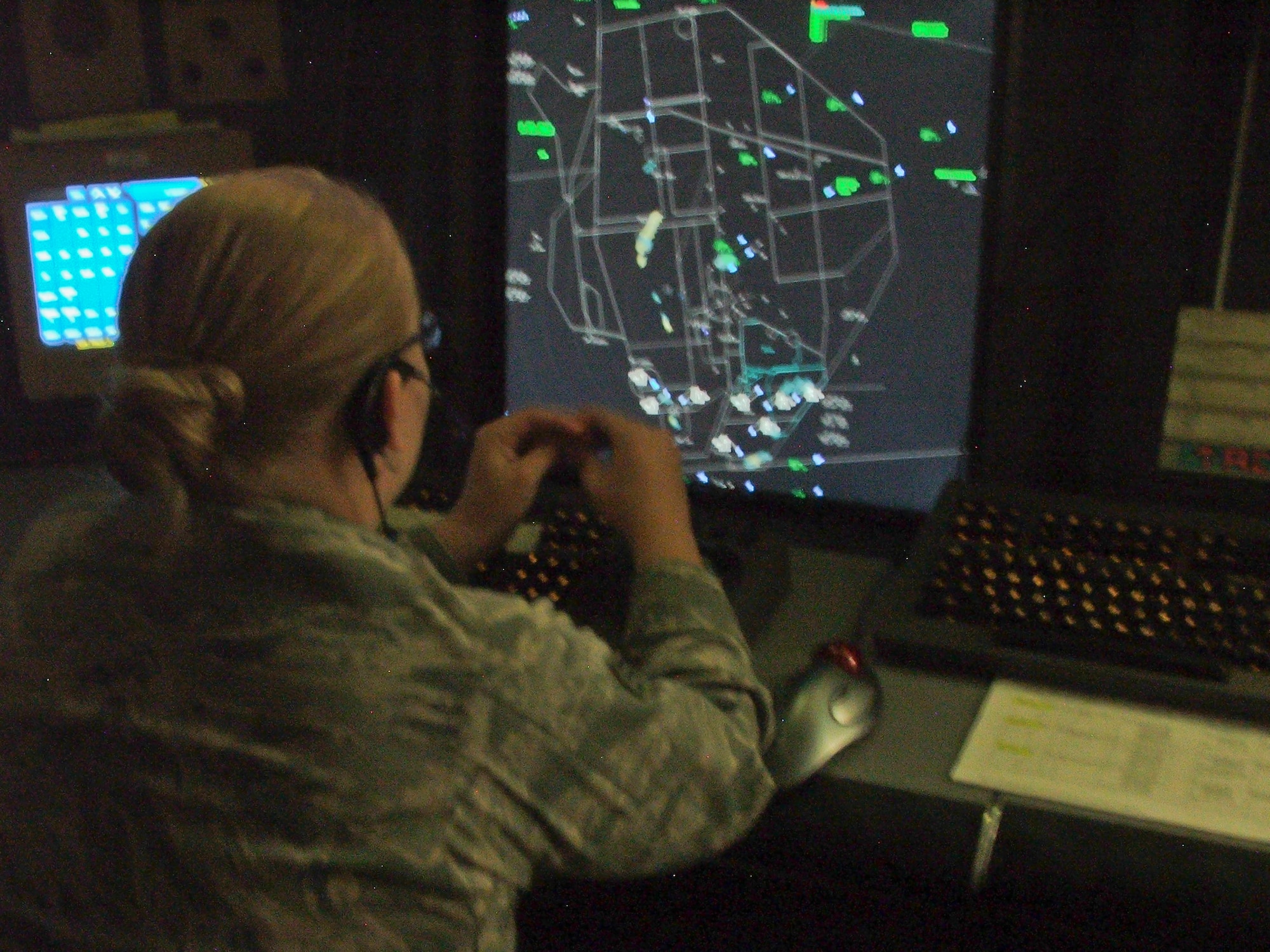 Senior Airman Caitlin Sullivan, 49th Operation Support Squadron air traffic controller, monitors the standard approach radar system at the J.W. Cox Range Control Center at White Sands Missile Range, N.M., Sept. 30. A standard approach radar system is a live feed which shows the correlation between aircraft and the airfield. Airmen from Holloman Air Force Base are stationed at WSMR to run the air traffic operations. (U.S. Air Force photo by Airman 1st Class Aaron Montoya/Released)