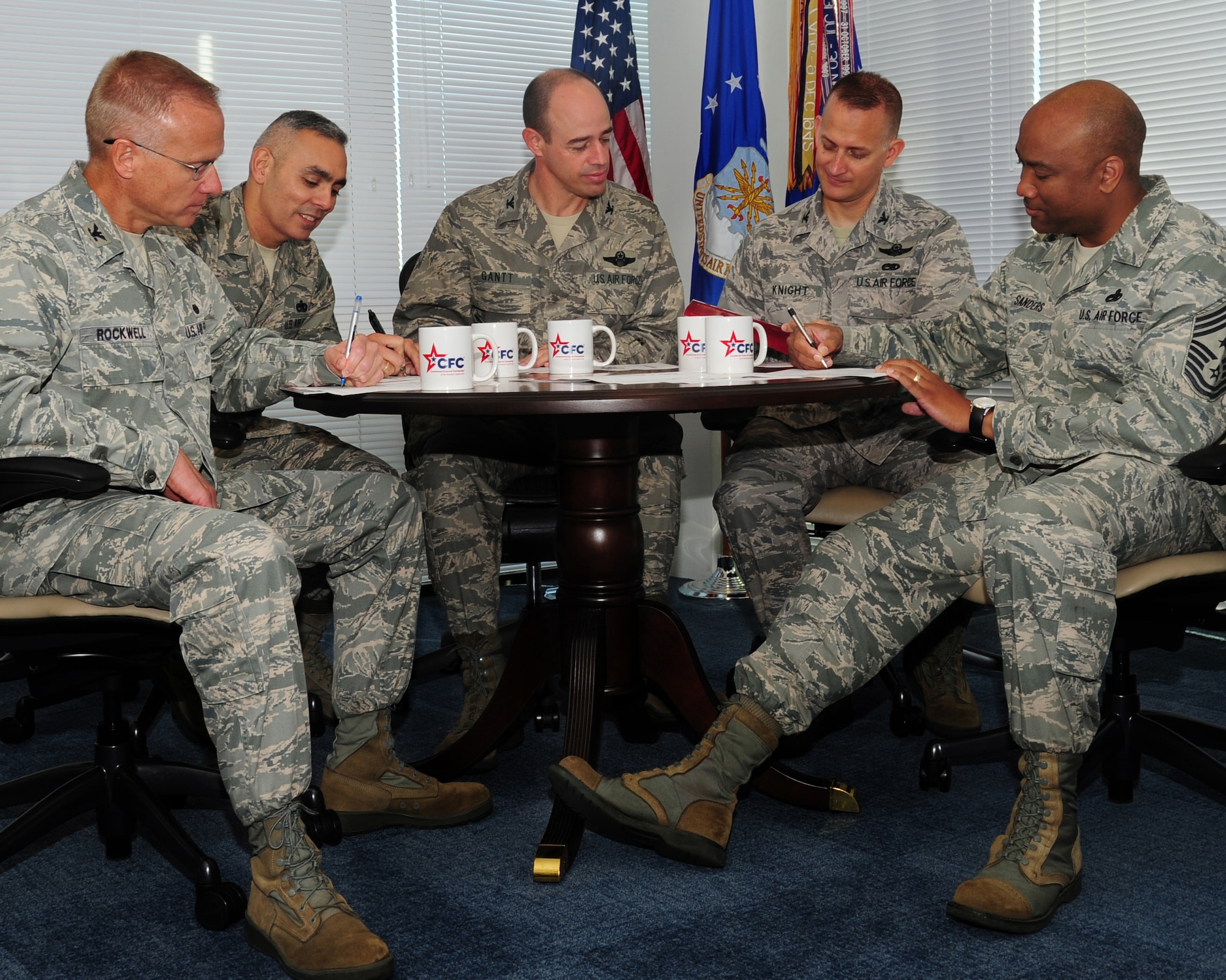 From left to right, Colonel Jeffrey Rockwell, Air Force Legal Operations Agency commander, Chief Master Sgt. Jose LugoSantiago, Air Force District of Washington command chief, Col. Michael Gantt, AFDW vice commander, Col. Bill Knight , 11th Wing/Joint Base Andrews commander, and Chief Master Sgt. William Sanders, 11 WG command chief, sign Combine Federal Campaign contribution forms at Joint Base Andrews, Md., Sept. 25, 2013. (U.S. Air Force photo/Airman 1st Class Erin O’Shea) 

