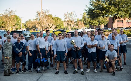 Members of the 628th Civil Engineer Squadron pose for a group photo after the Commander’s Challenge Run Oct. 4, 2013, at Joint Base Charleston – Air Base, S.C. The Commander's Challenge is held monthly to test Team Charleston's fitness abilities. The Spirit Award was given to the 628th CES. (U.S. Air Force photo/ Senior Airman Dennis Sloan)