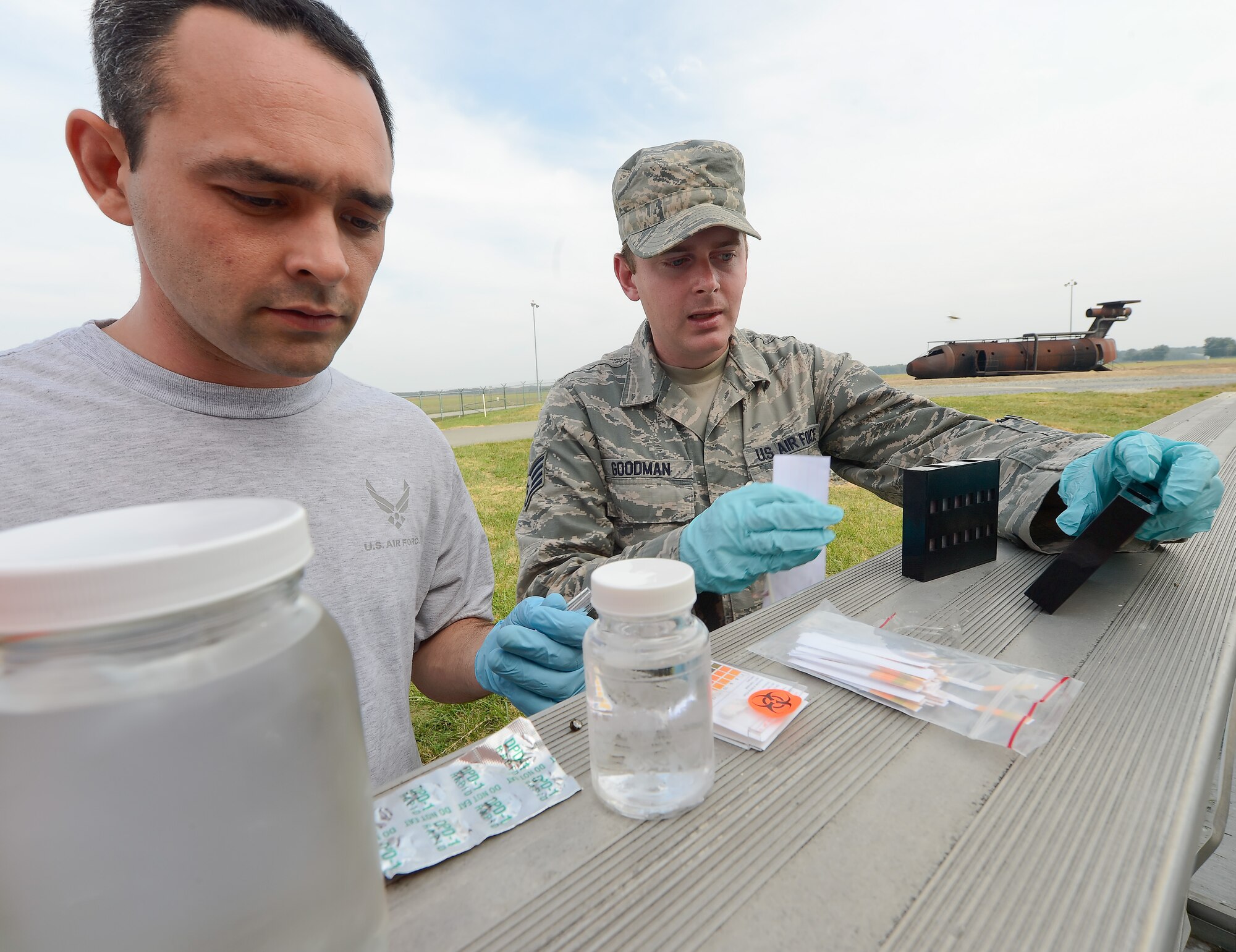 Senior Airman Joseph Davis, (left) 436th Civil Engineer Squadron, Emergency Management Section, and Staff Sgt. Aaron Goodman, 436th Medical Group, Biological-Environmental section, test water for contaminants and purity during a training exercise at Dover Air Force Base, Del. on Oct. 3, 2013. The exercise tested the bases ability to respond to a natural disaster and resulting contamination to water supplies. (U.S. Air Force photo/Greg L. Davis)