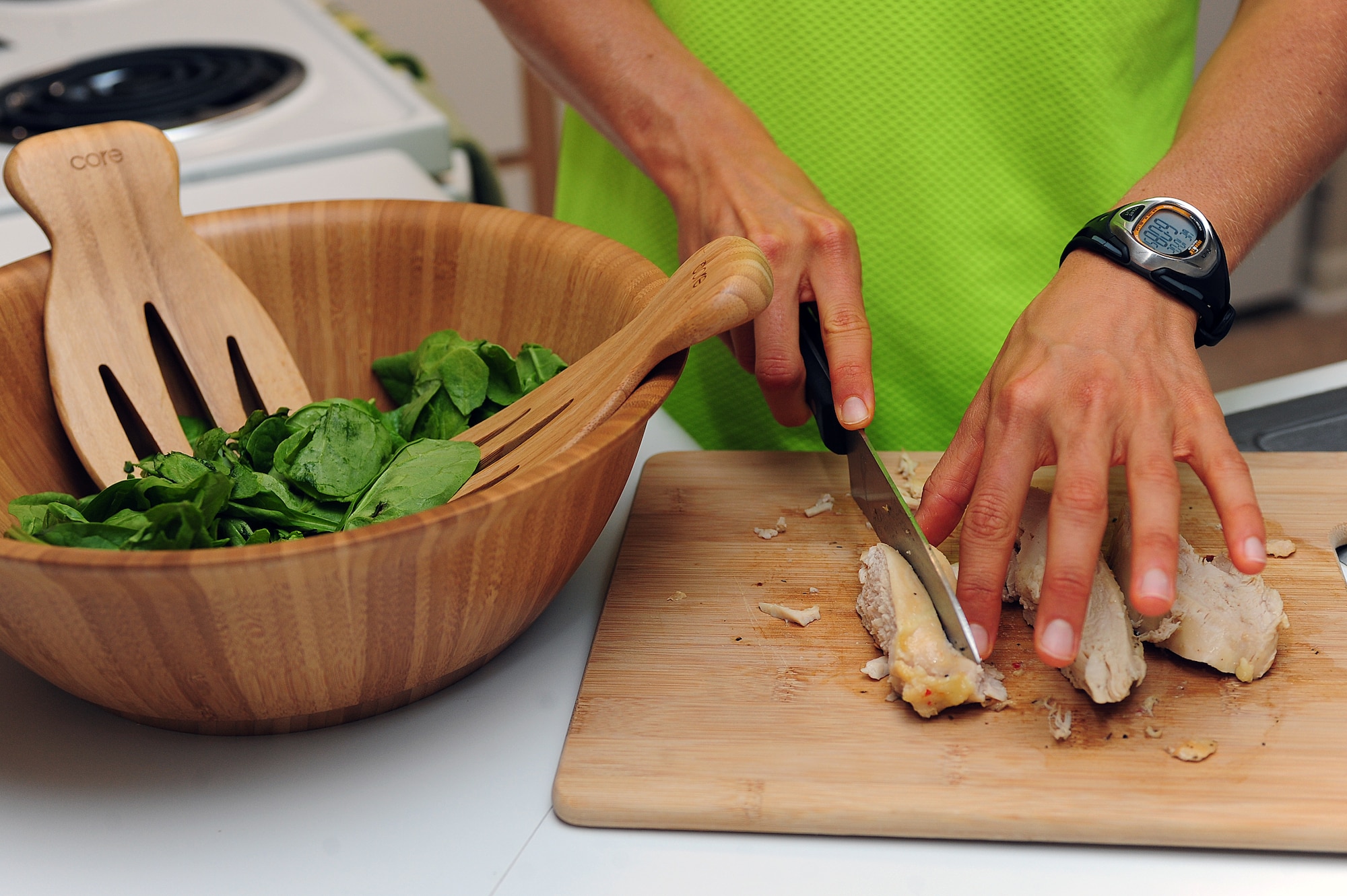 U.S. Air Force 2nd Lt. Samantha Morrison, 4th Fighter Wing Public Affairs deputy chief, prepares chicken and spinach for a post-workout meal at her home in Goldsboro, N.C., Oct. 2, 2013. Morrison maintains an all-natural food diet in preparation for the IRONMAN World Championship in Kailua-Kona, Hawaii, Oct. 12, 2013. She is looking to improve on her third place finish in the 2012 event. (U.S. Air Force photo by Airman 1st Class John Nieves Camacho)