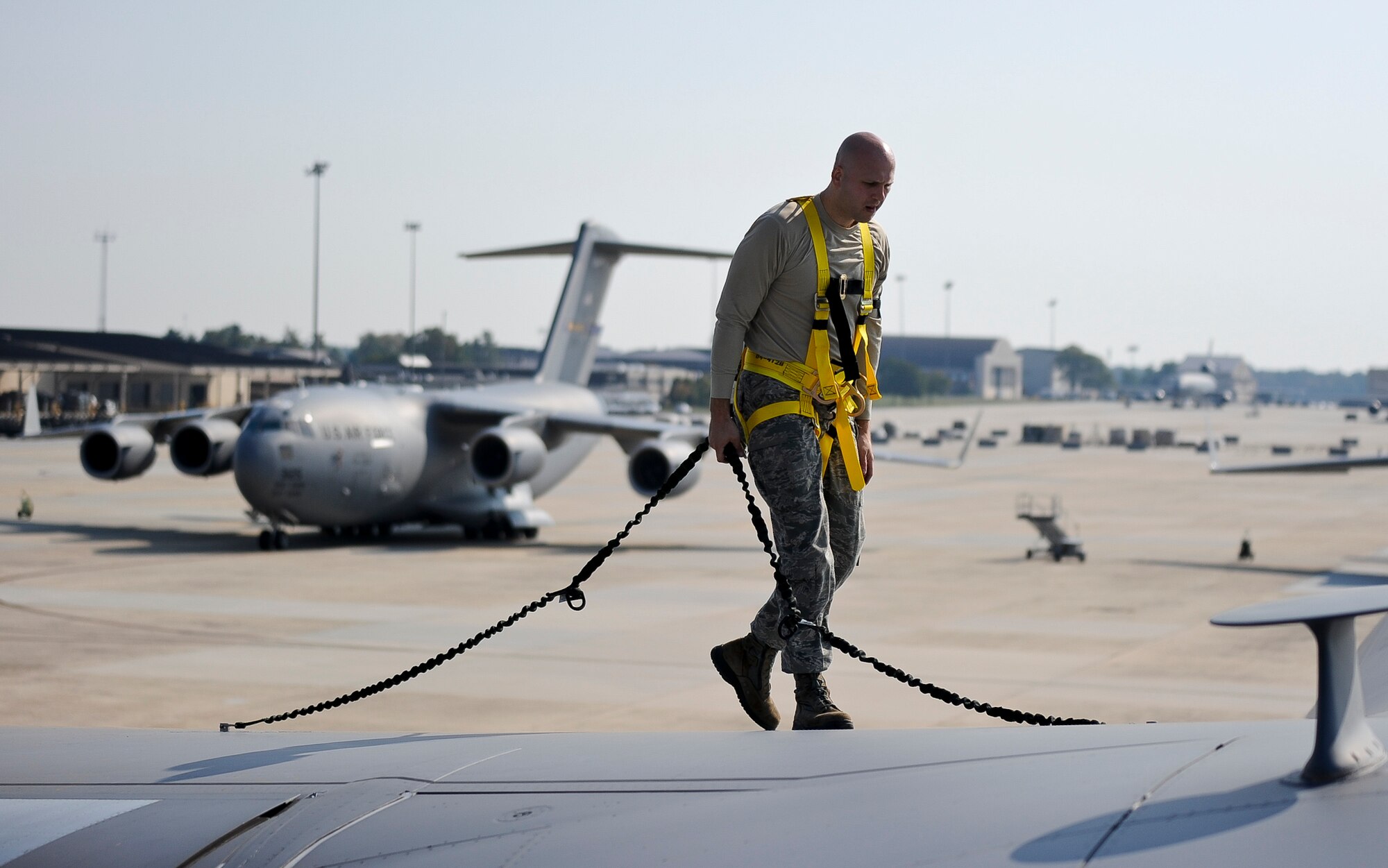 Tech. Sgt. Scott Langevin, 305th Aircraft Maintenance Squadron flying crew chief, walks the right wing of a C-17 Globemaster III to inspect for a hydraulic leak Oct. 4, 2013, on McGuire Field at Joint Base McGuire-Dix-Lakehurst, N.J. The flightline is still operating 24/7 despite the loss of civilian and air reserve technicians. "We will always be here to get the mission done, but we have felt the loss of our civilian and ART counterparts," said Master Sgt. Nathan Johnson, 305th AMXS production superintendent. "The average Airmen on the flightline has about four years of experience whereas the others have upwards of 12." (U.S. Air Force photo by Airman 1st Class Ryan Throneberry/Released)