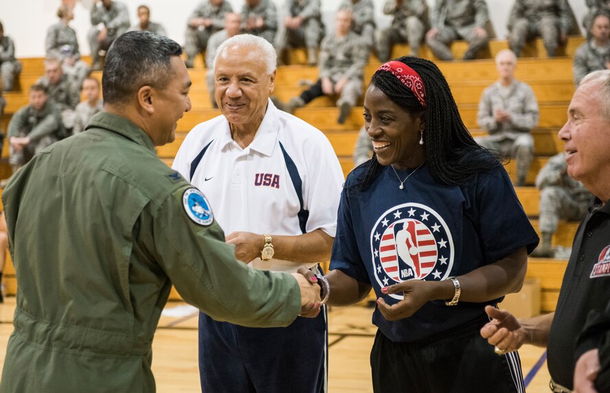 Col. Sarady Tan (left), 366th Medical Group commander, presents a 366th Fighter Wing challenge coin to WNBA star Ruthie Bolton following a five-on-five basketball game at Mountain Home Air Force Base, Idaho, Oct. 4, 2013. Bolton, along with NBA legend Lenny Wilkens coached the two teams as part of a kick-off for Healthy Base Initiative at Mountain Home AFB. (U.S. Air Force photo by Tech. Sgt. Samuel Morse /Released)