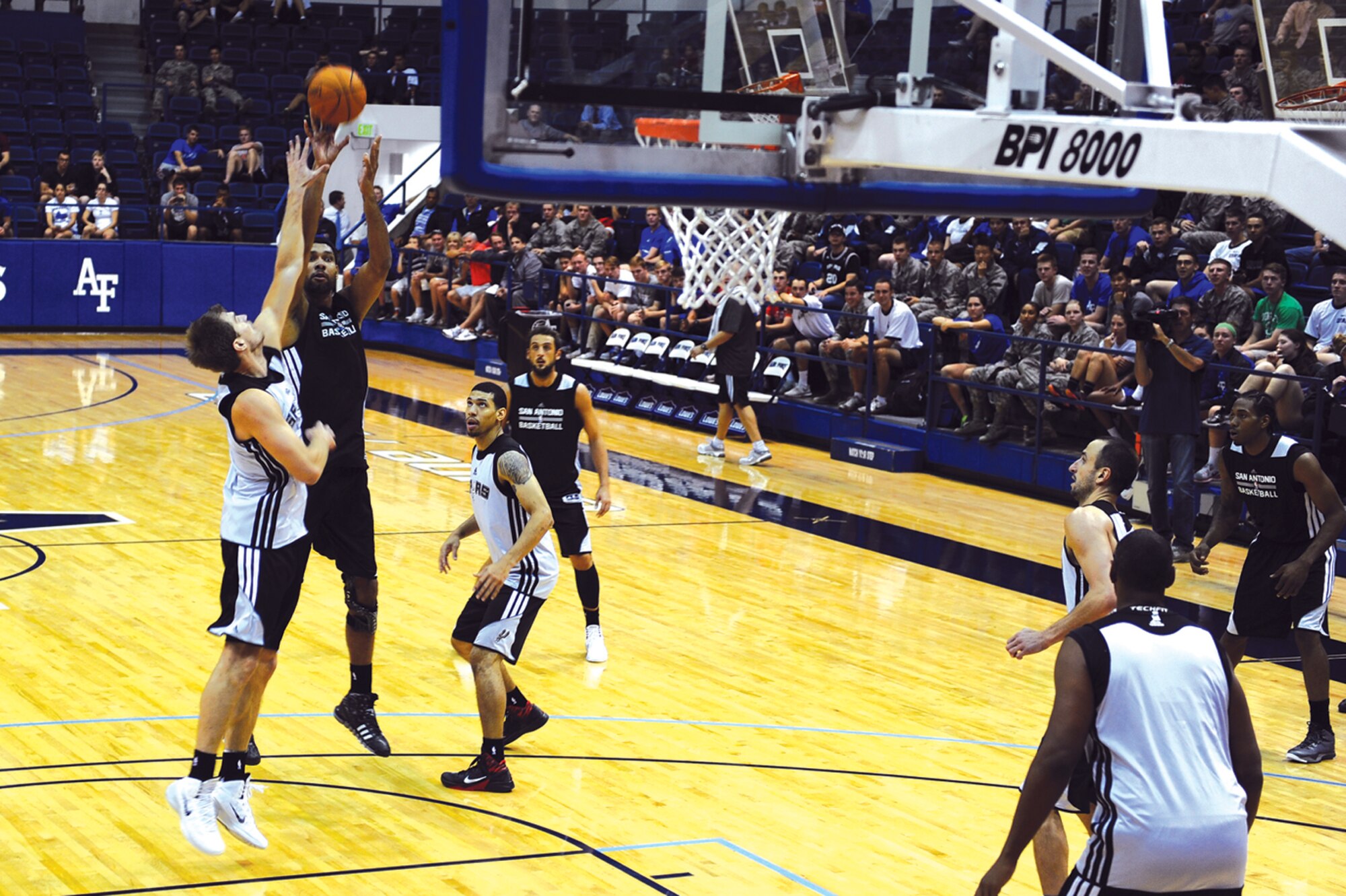 Spurs star forward Tim Duncan (second from left) goes up for a shot during Wednesday evening's practice session at Clune Arena. The Spurs opened their training camp here Oct. 1. (U.S. Air Force Photo/Master Sgt. Kenneth Bellard)