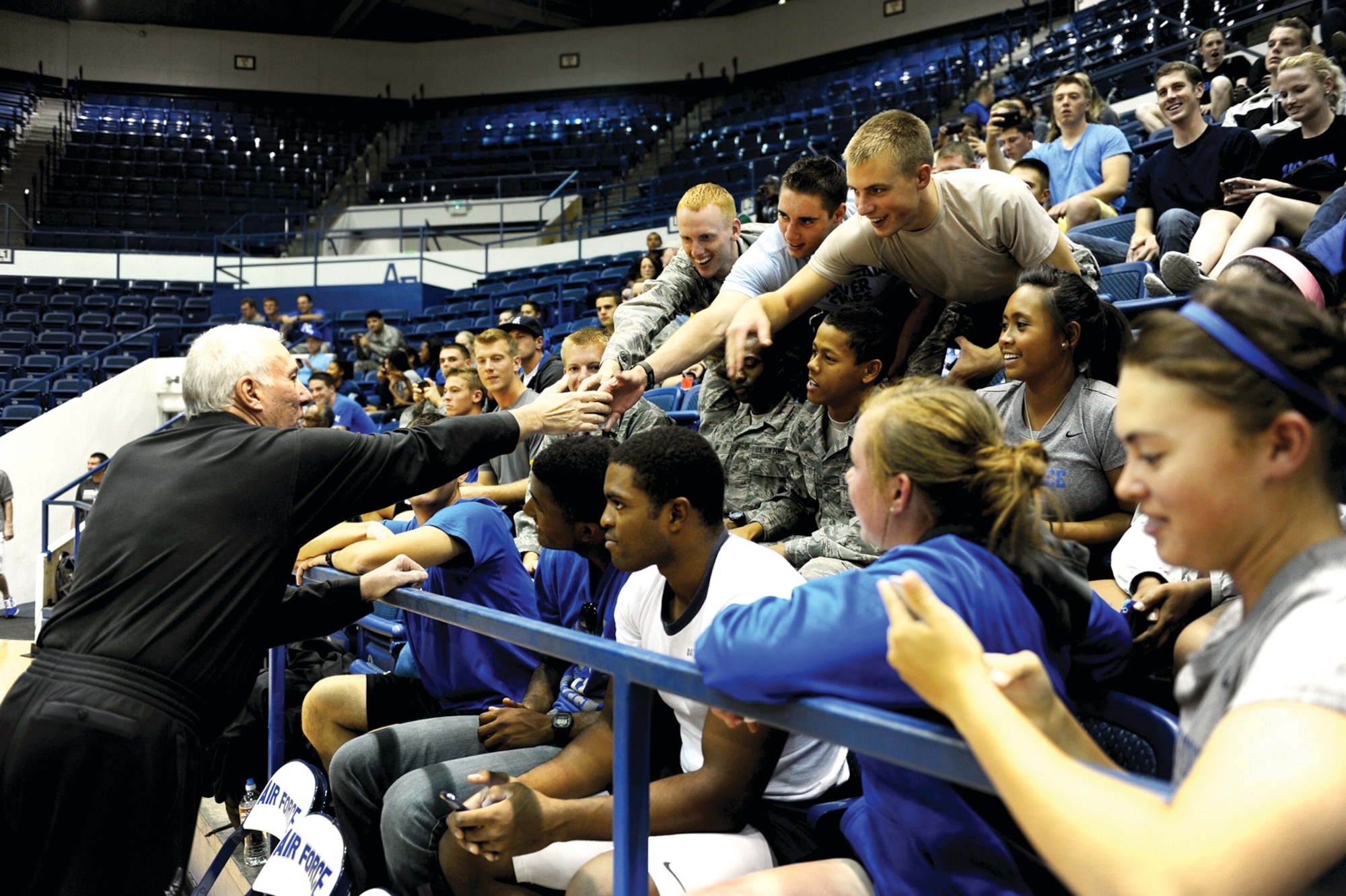 Academy cadets reach out to shake hands with Spurs head coach Gregg Popovich before the start of the team's practice Wednesday at Clune Arena. (U.S. Air Force Photo/Master Sgt. Kenneth Bellard)