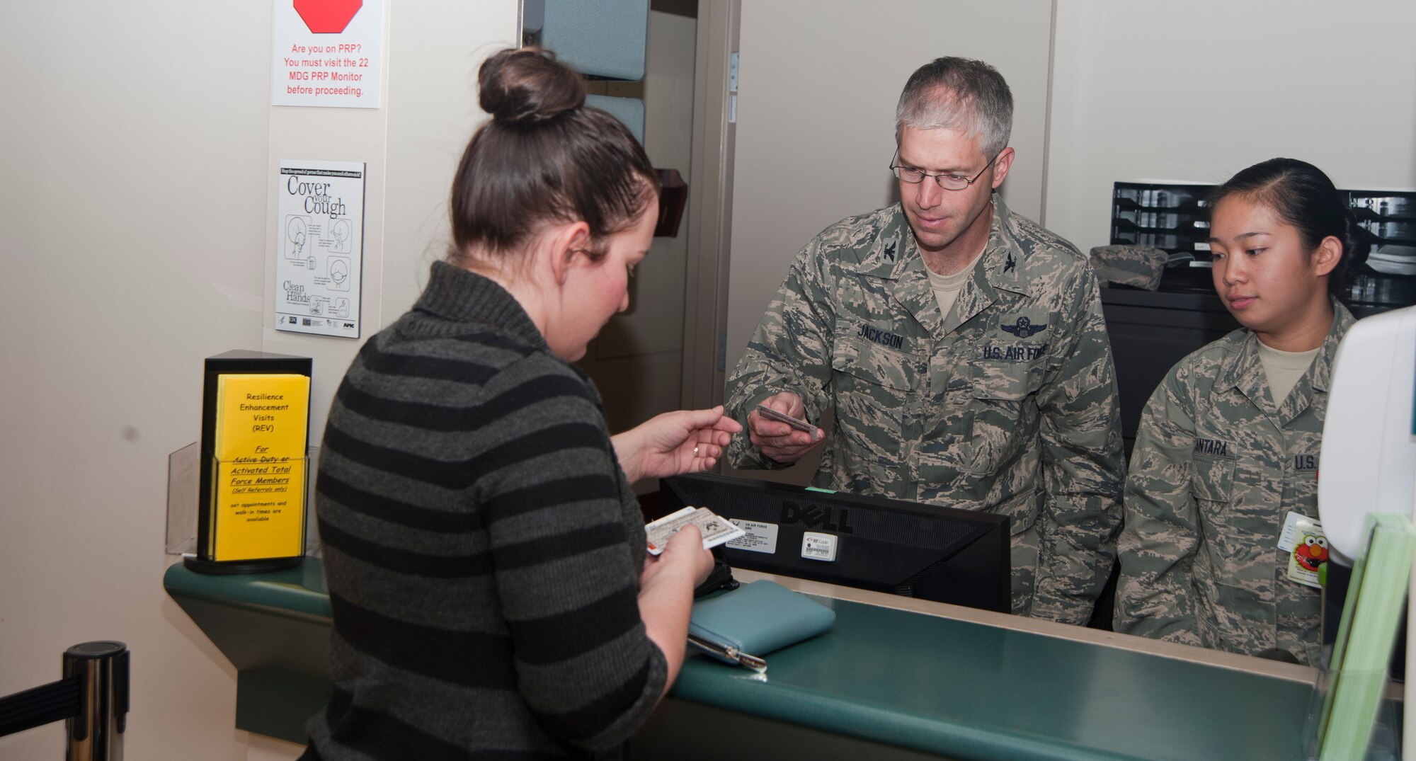 Col. Joel Jackson, 22nd Air Refueling Wing commander, checks a patient's ID card Sept. 23, 2013. Jackson was performing one of the many duties of a medical technician as part of a new program introduced. The program will give Jackson hands on experience as if he were an Airmen working a typical duty day. (U.S. Air Force photo/Airman 1st Class Colby L. Hardin) 