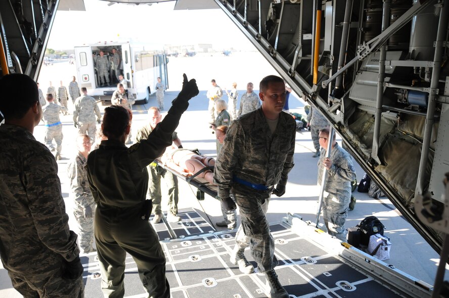 Lt. Col. Monsita Faley, 34th Air Evacuation Squadron commander, Peterson Air Force Base, Colo., guides Senior Airmen Robert Wallen, 944th Aeromedical Staging Squadron, onto a C-130 Hercules transport during Operation Swift Savior, a four-day joint exercise with the Carl T. Hayden VA Medical Center Sept. 16 through 20 at Luke Air Force Base. (U.S. Air Force photo/Staff Sgt. Joshua Nason)