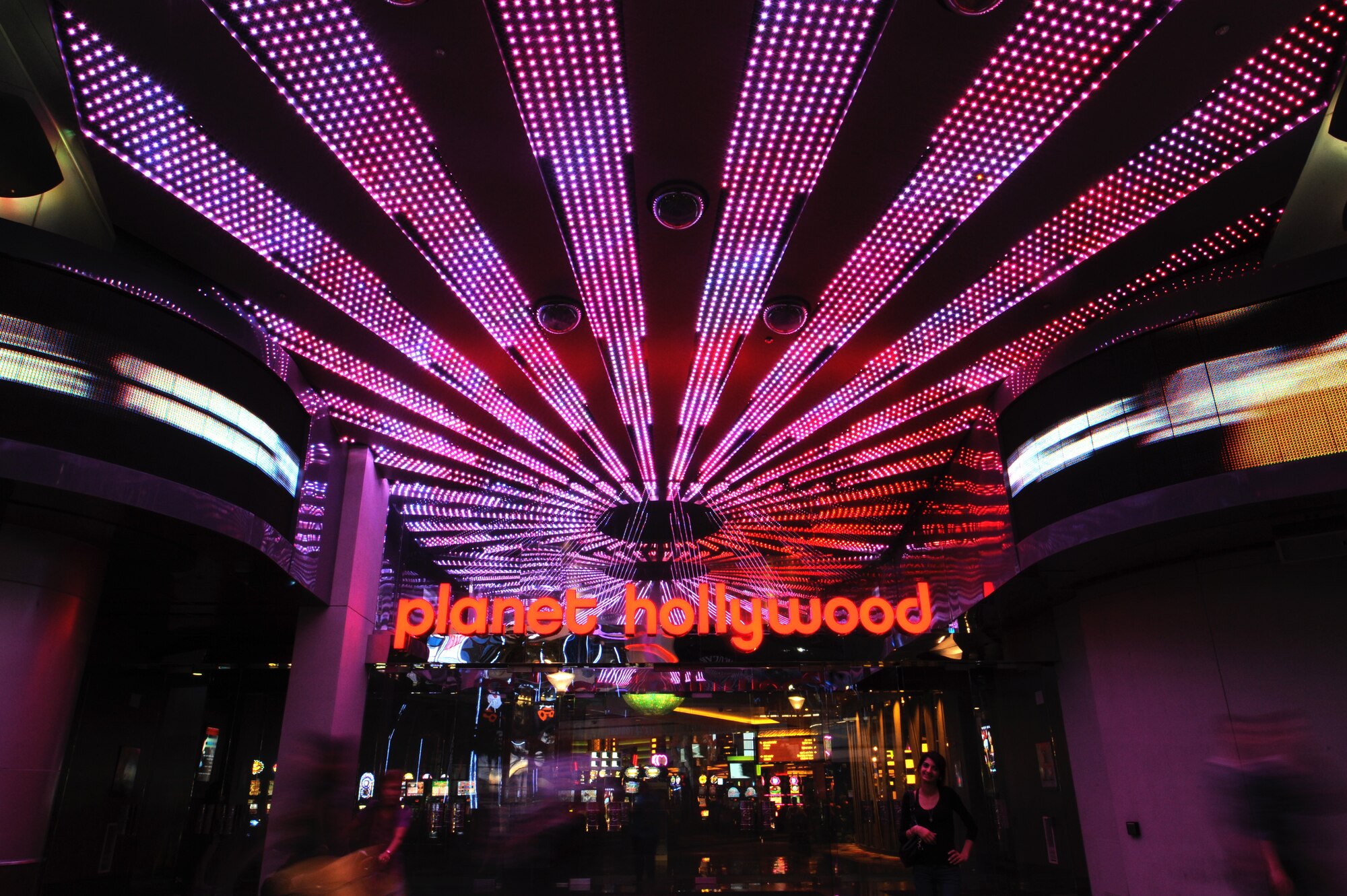 Tourists pose for photos at the entrance to Planet Hollywood Resort and Casino. The resort is located in the Miracle Mile shops and offers a variety of shows including tribute shows, magicians and an Evil Dead 4-D stage musical. (U.S. Air Force photo/Staff Sgt. Nestor Cruz)
