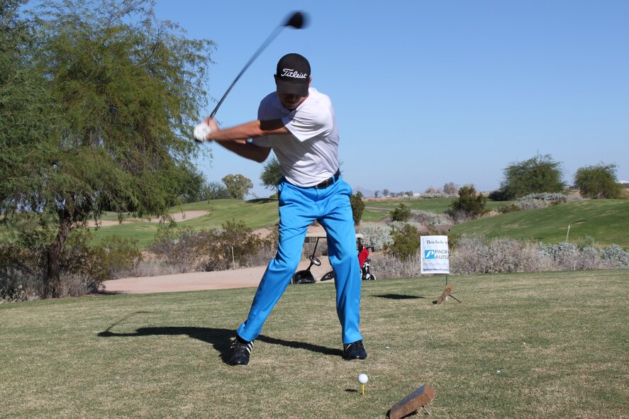 Senior Airman Ronald Gore, 56th Communications Squadron Airfield Systems journeyman, winds up his swing at Falcon Dunes Golf Course. Gore has been selected to participate in the Heroes Cup later this month. (U.S. Air Force photo/Jayson Burns)
