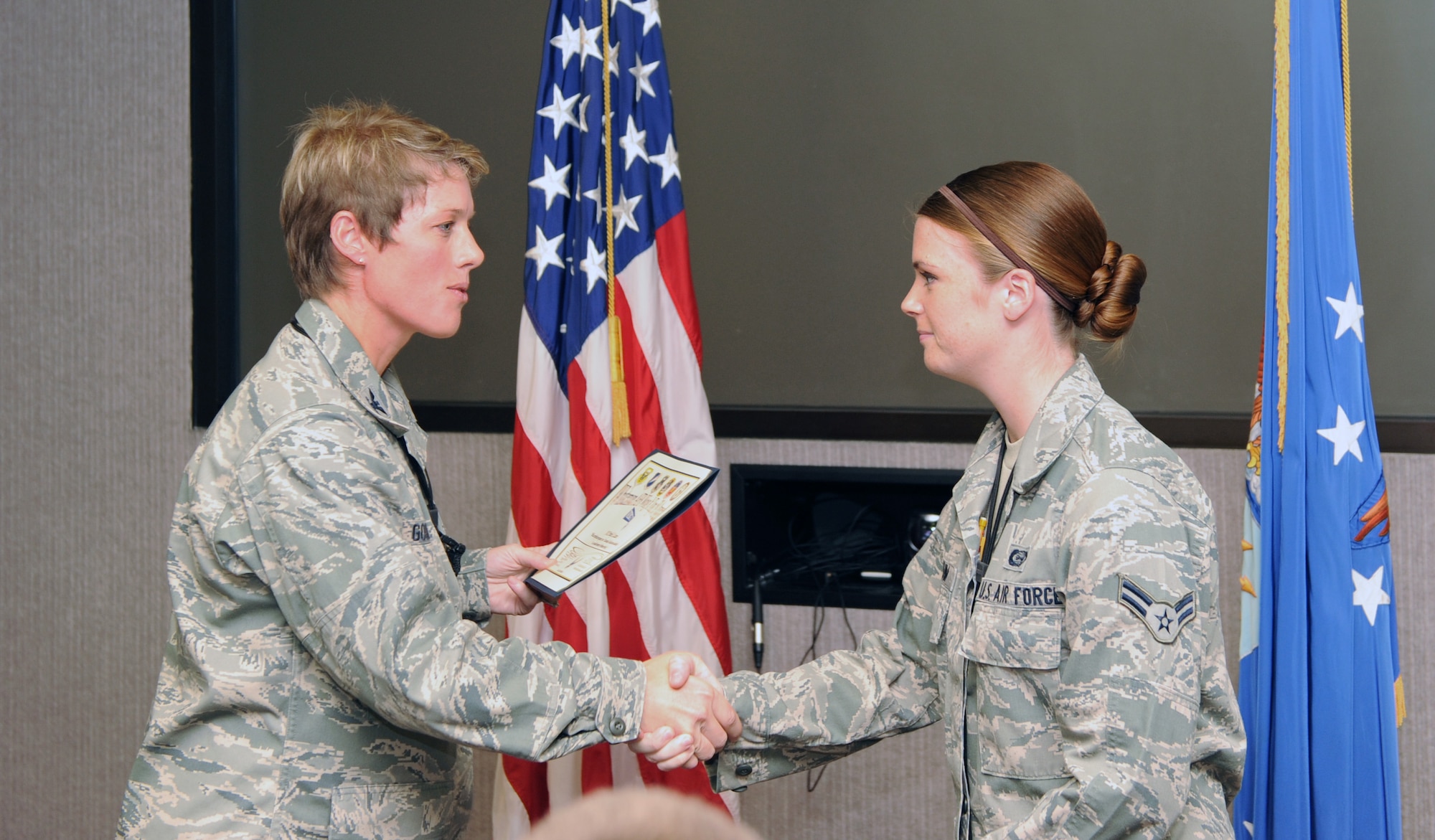 U.S. Air Force Col. Kristin Goodwin, 509th Bomb Wing vice commander, presents the Spirit Award to U.S. Air Force Airman 1st Class Emily Luzum, 509th Operations Support Squadron intelligence analyst, Sept. 25, 2013, at Whiteman Air Force Base, Mo. Luzum was also awarded the Diamond Sharp Award from Whiteman’s first sergeants. (U.S. Air Force photo by Jennifer Greene/Released)