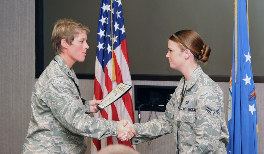 U.S. Air Force Col. Kristin Goodwin, 509th Bomb Wing vice commander, presents the Spirit Award to U.S. Air Force Airman 1st Class Emily Luzum, 509th Operations Support Squadron intelligence analyst, Sept. 25, 2013, at Whiteman Air Force Base, Mo. Luzum was also awarded the Diamond Sharp Award from Whiteman’s first sergeants. (U.S. Air Force photo by Jennifer Greene/Released)