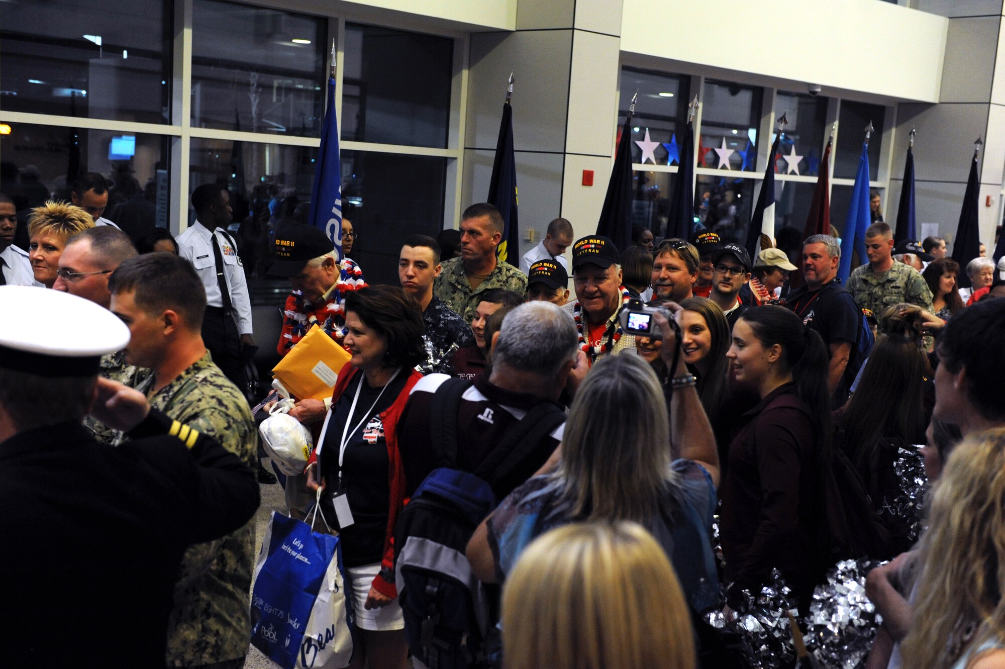 Family and friends celebrate the return of World War II veterans with the Mississippi Gulf Coast Honor Flight to Washington, D.C., Oct 1, 2013, at the Gulfport/Biloxi International Airport. The Honor Flight is a nonprofit program that sends veterans to Washington, D.C., to see national monuments. (U.S. Air Force photos by Airman 1st Class Stephan Coleman)