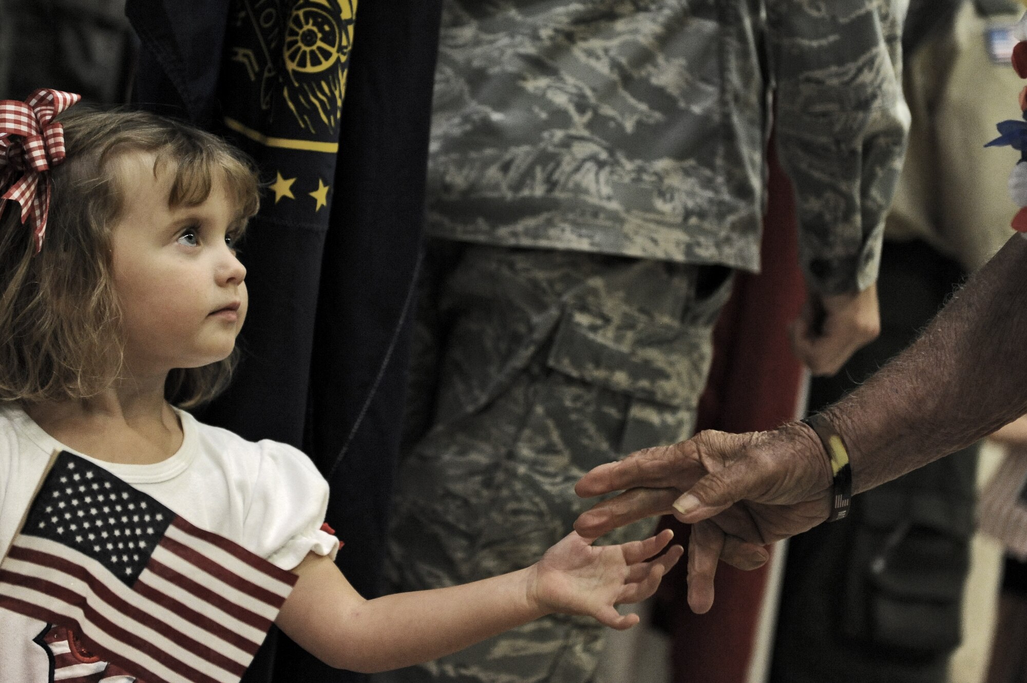 A young girl greets a World War II veteran from the Mississippi Gulf Coast Honor Flight to Washington, D.C., at the Gulfport/Biloxi International on Oct 1, 2013. The Honor Flight is a nonprofit program that sends veterans to Washington, D.C., to see national monuments. (U.S. Air Force photos by Airman 1st Class Stephan Coleman)