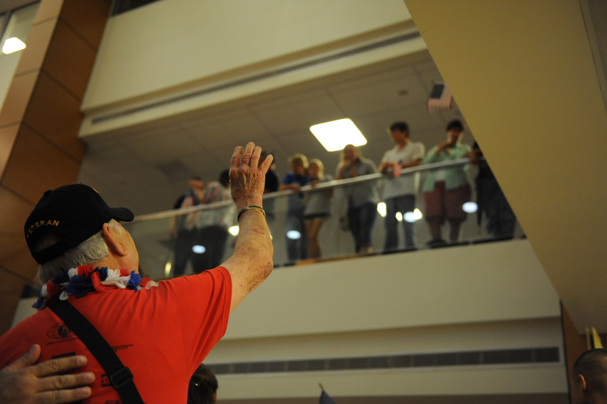 A World War II veteran waves to supporters at the Gulfport/Biloxi International Airport after returning from the Mississippi Gulf Coast Honor Flight to Washington, D.C., Oct 1, 2013. The Honor Flight is a nonprofit program that sends veterans to see national monuments in Washington, D.C., to honor them for their service. (U.S. Air Force photos by Airman 1st Class Stephan Coleman)