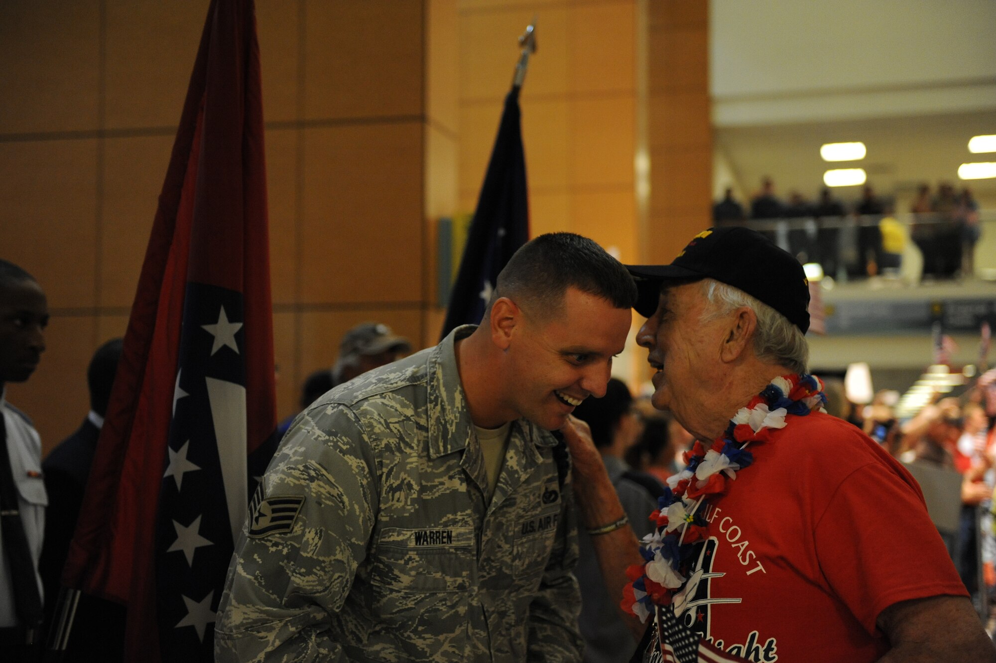 Staff Sgt. Russell Warren, 338th Training Squadron military training leader, welcomes a World War II veteran who returned from the Mississippi Gulf Coast Honor Flight to Washington, D.C., at the Gulfport/Biloxi International on Oct 1, 2013. The Honor Flight is a nonprofit program that sends veterans to Washington, D.C., to see national monuments. (U.S. Air Force photos by Airman 1st Class Stephan Coleman)