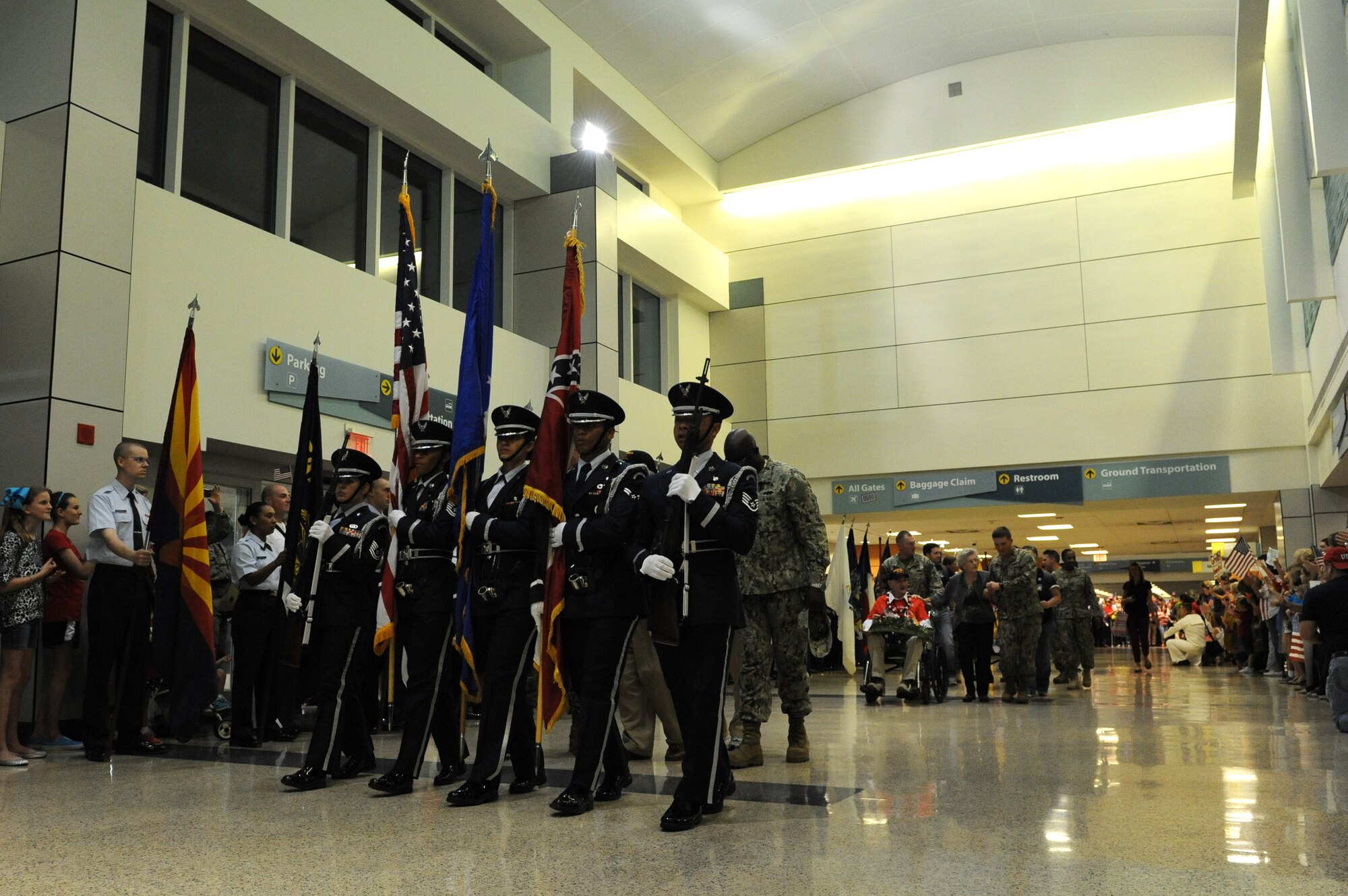 Keesler Honor Guard members march in front of World War II veterans with the Mississippi Gulf Coast Honor Flight to Washington, D.C., Oct 1, 2013, at the Gulfport/Biloxi International Airport. The Honor Flight is a nonprofit program that sends veterans to Washington, D.C., to see national monuments. (U.S. Air Force photos by Airman 1st Class Stephan Coleman)