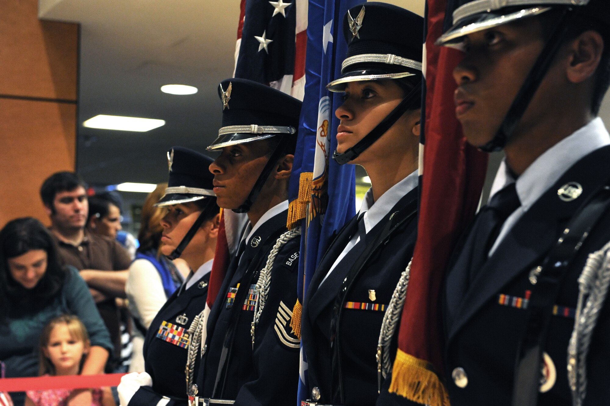 Tech. Sgt. Kristy Crespo, Tech. Sgt. Kimberly Williams-Mason, Airman 1st Class Jennifer Balcazar and Airman 1st Class Peterson Peter, Keesler Honor Guard members, wait for World War II veterans with the Mississippi Gulf Coast Honor Flight to return from Washington, D.C., Oct 1, 2013, at the Gulfport/Biloxi International Airport. The Honor Flight is a nonprofit program that sends veterans to Washington, D.C., to see national monuments. (U.S. Air Force photos by Airman 1st Class Stephan Coleman)
