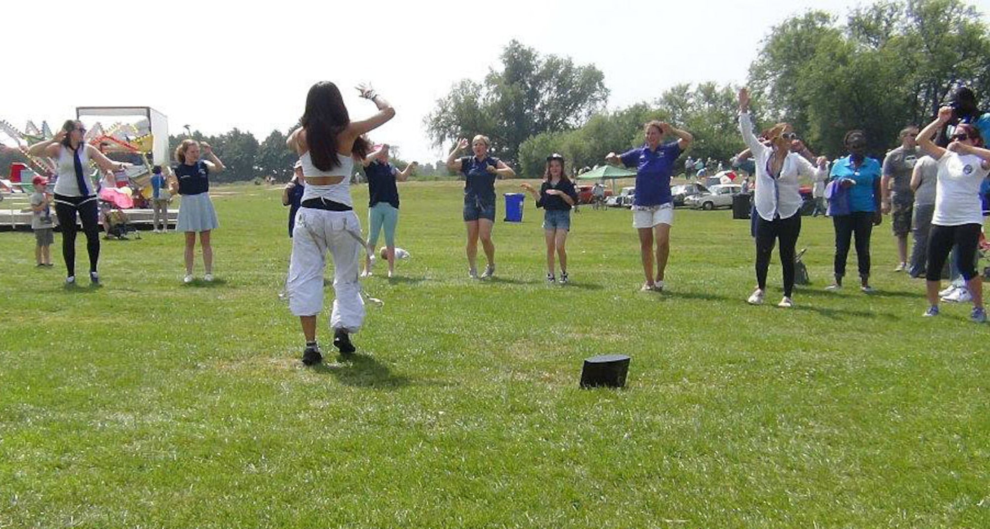 Antoinette “Anne Spiration” Mendoza, certified official Zumba instructor, leads a workout demo at Royal Air Force Mildenhall, England, July 13, 2013. Zumba is a Latin-inspired dance program that incorporates salsa, reggae, hip-hop and many other dance styles for a full-body aerobic workout. (Courtesy photo)  