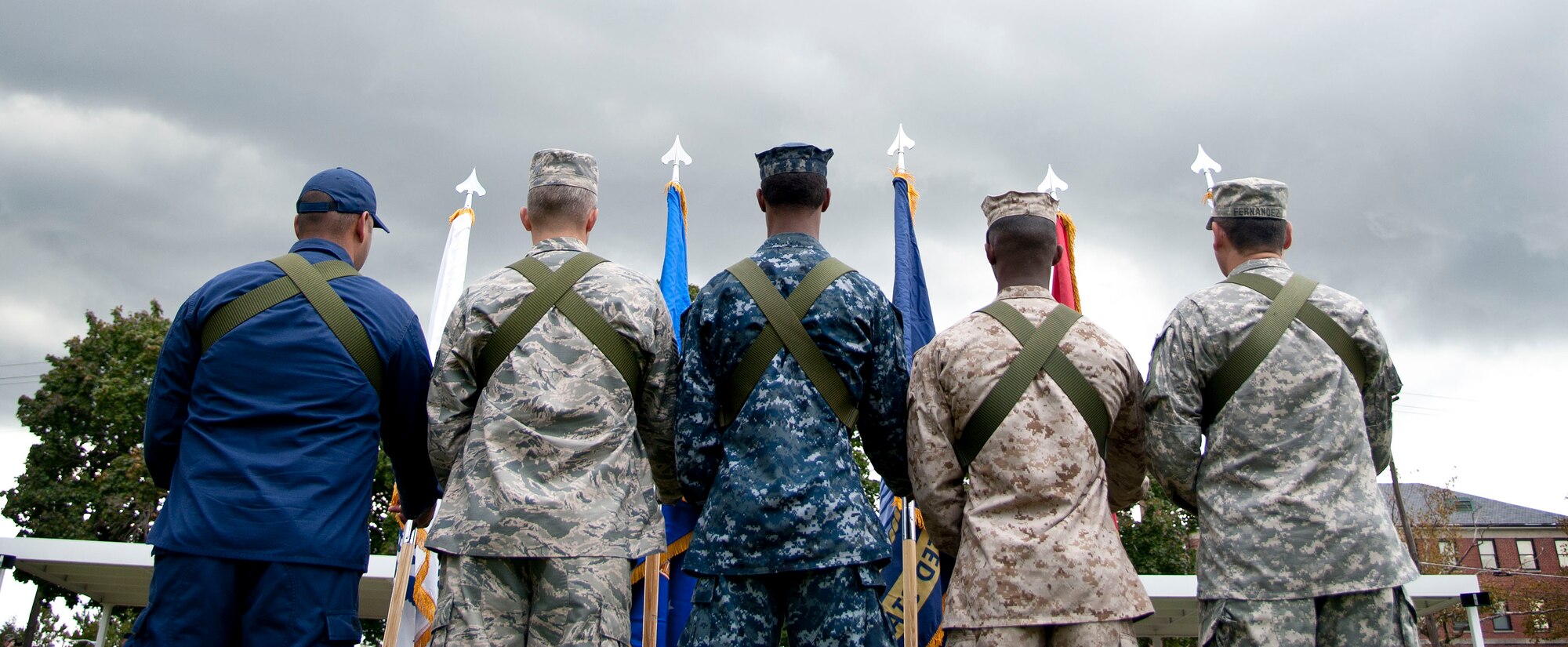 A color guard formation representing all five services stands at parade rest durig the inaugural joint base retreat ceremony Sept. 26, 2013, on Sharpe Field at Joint Base McGuire-Dix-Lakehurst, N.J. (U.S. Air Force photo by Staff Sgt. Katherine Tereyama/Released)