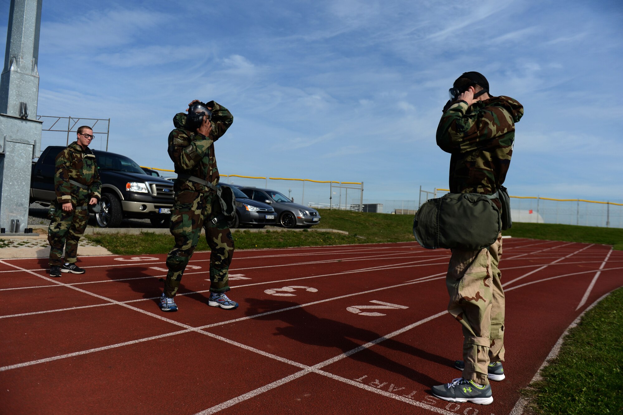 SPANGDAHLEM AIR BASE, Germany – Airmen prepare to run in a chemical protective gear relay during Spangdahlem’s Sports Day Oct. 3, 2013. During the relay, Airmen needed to correctly don their protective gear before running 100 meters and tagging their teammate. (U.S. Air Force photo by Airman 1st Class Gustavo Castillo/Released) 