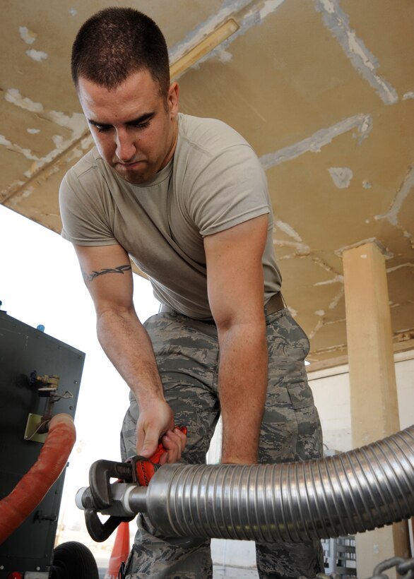 Senior Airman Dustin Shuman secures an attachment to a hose on a liquid oxygen tank while doing repairs at the 379th Air Expeditionary Wing in Southwest Asia, Oct. 2, 2013. The 379th Expeditionary Logistics Readiness Squadron cryogenics shop also repairs broken tanks in addition to providing liquid oxygen and nitrogen to bases throughout the Air Force Central Command area of responsibility. Shuman is a 379th Expeditionary Logistics Readiness Squadron cryogenics technician deployed from Scott Air Force Base, Ill., and hails from Orrville, Ohio. (U.S. Air Force photo/Senior Airman Bahja J. Jones) 