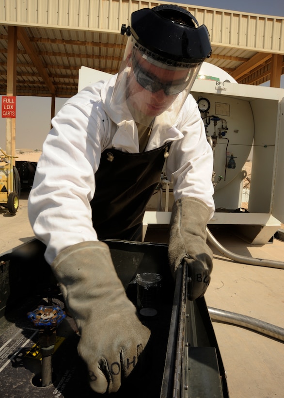 Senior Airman John Justiniano opens a valve to control the amount of liquid oxygen filling a cart at the 379th Air Expeditionary Wing in Southwest Asia, Oct. 1, 2013. Justiniano is a 379th Expeditionary Logistics Readiness Squadron cryogenics technician deployed from Joint Base Langley-Eustis, Va., and hails from Bronx, N.Y. (U.S. Air Force photo/Senior Airman Bahja J. Jones) 
