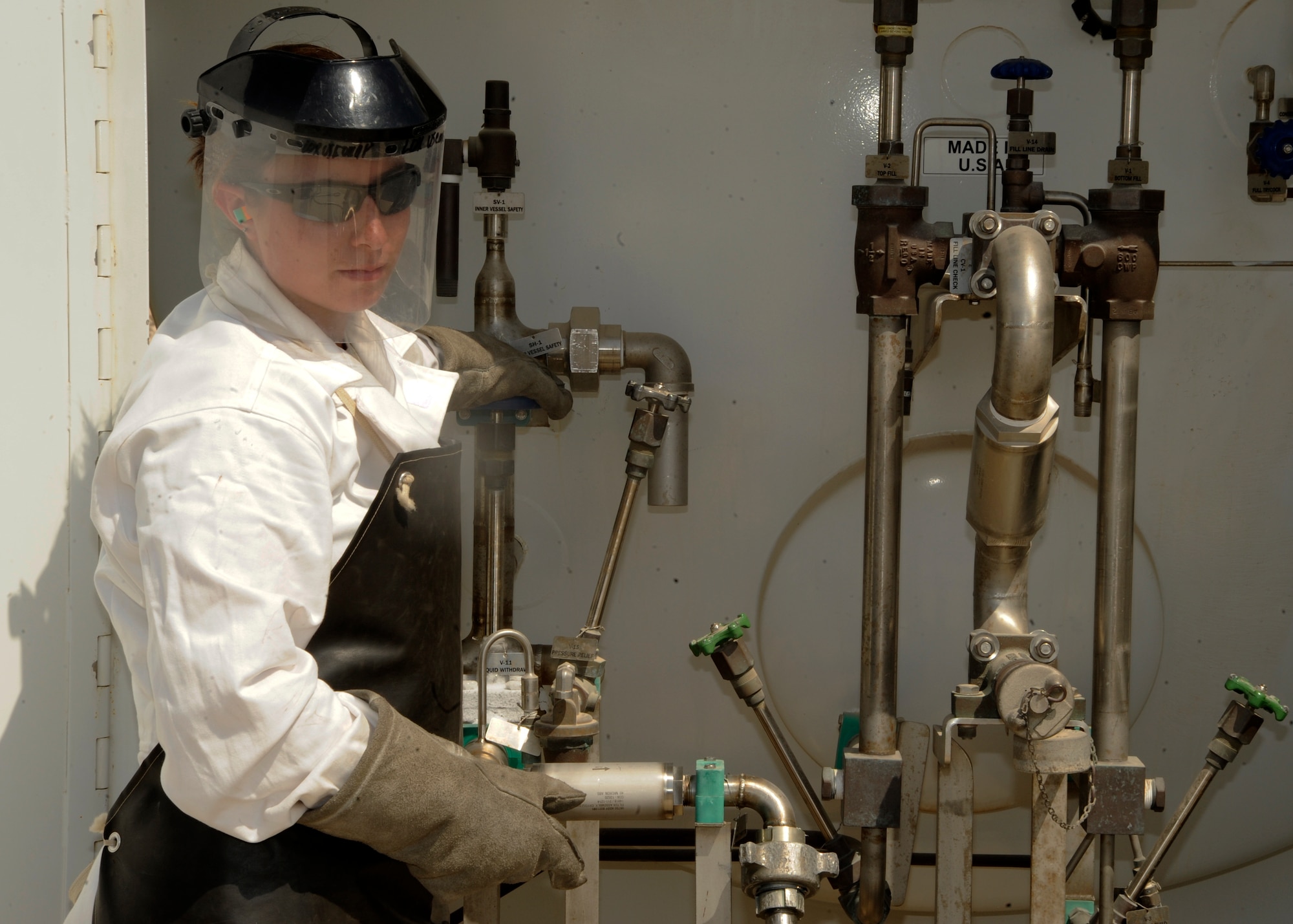 Staff Sgt. Sarah Sarten uses valves to control the pressure of liquid oxygen while filling a cart at the 379th Air Expeditionary Wing in Southwest Asia, Oct. 1, 2013. 
Cryogenics technicians work with “compressed gases,” distributing them as needed to support missions throughout the entire U.S. Air Forces Central Command area of responsibility. Sarten is the379th Expeditionary Logistics Readiness Squadron cryogenics supervisor deployed from Scott Air Force Base, Ill., and a Concord, N.C., native. (U.S. Air Force photo/Senior Airman Bahja J. Jones) 
