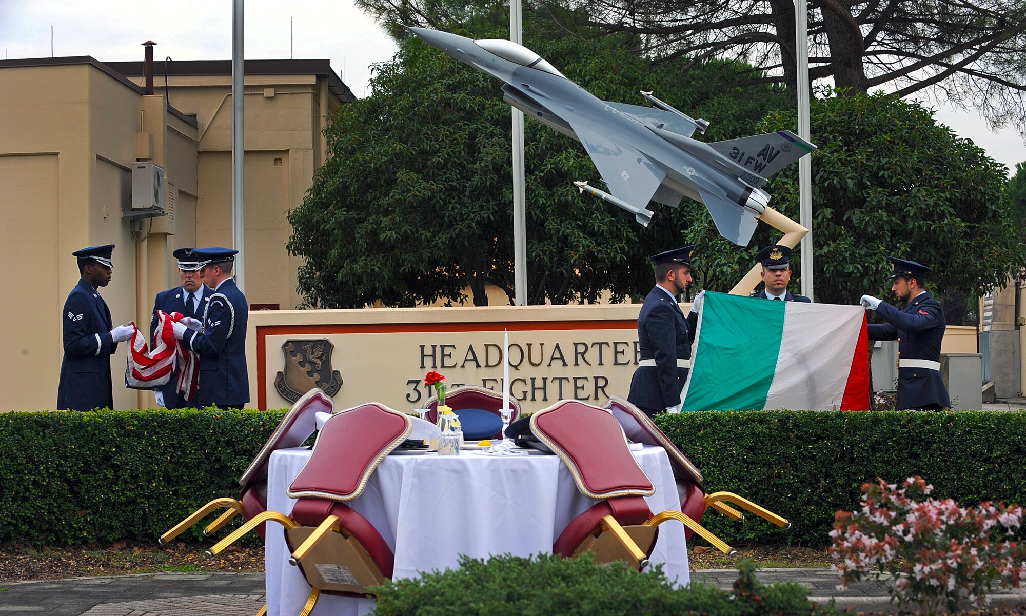 Honor guard Airmen and Italian air force members fold their countries’ flag during a Prisoners of war/Missing in action ceremony, Oct. 3, 2013, at Aviano Air Base, Italy. The ceremony concluded the POW/MIA week commemoration. (U.S. Air Force photo/Airman 1st Class Matthew Lotz)