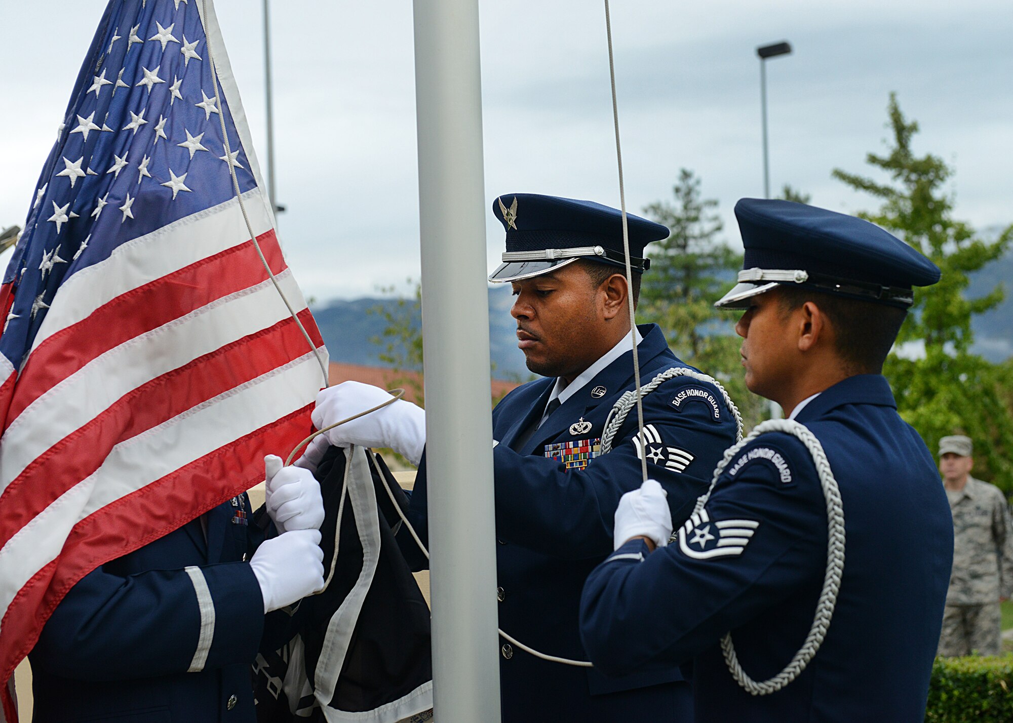Members of Aviano’s base honor guard team attach the Prisoners of war/Missing in action memorial flag during a reveille ceremony , Sept. 30, 2013, at Aviano Air Base, Italy. Aviano spent the week of Sept. 30 to Oct. 4, remember those who are missing or captured while serving their country. (U.S. Air Force photo/Airman Ryan Conroy) 