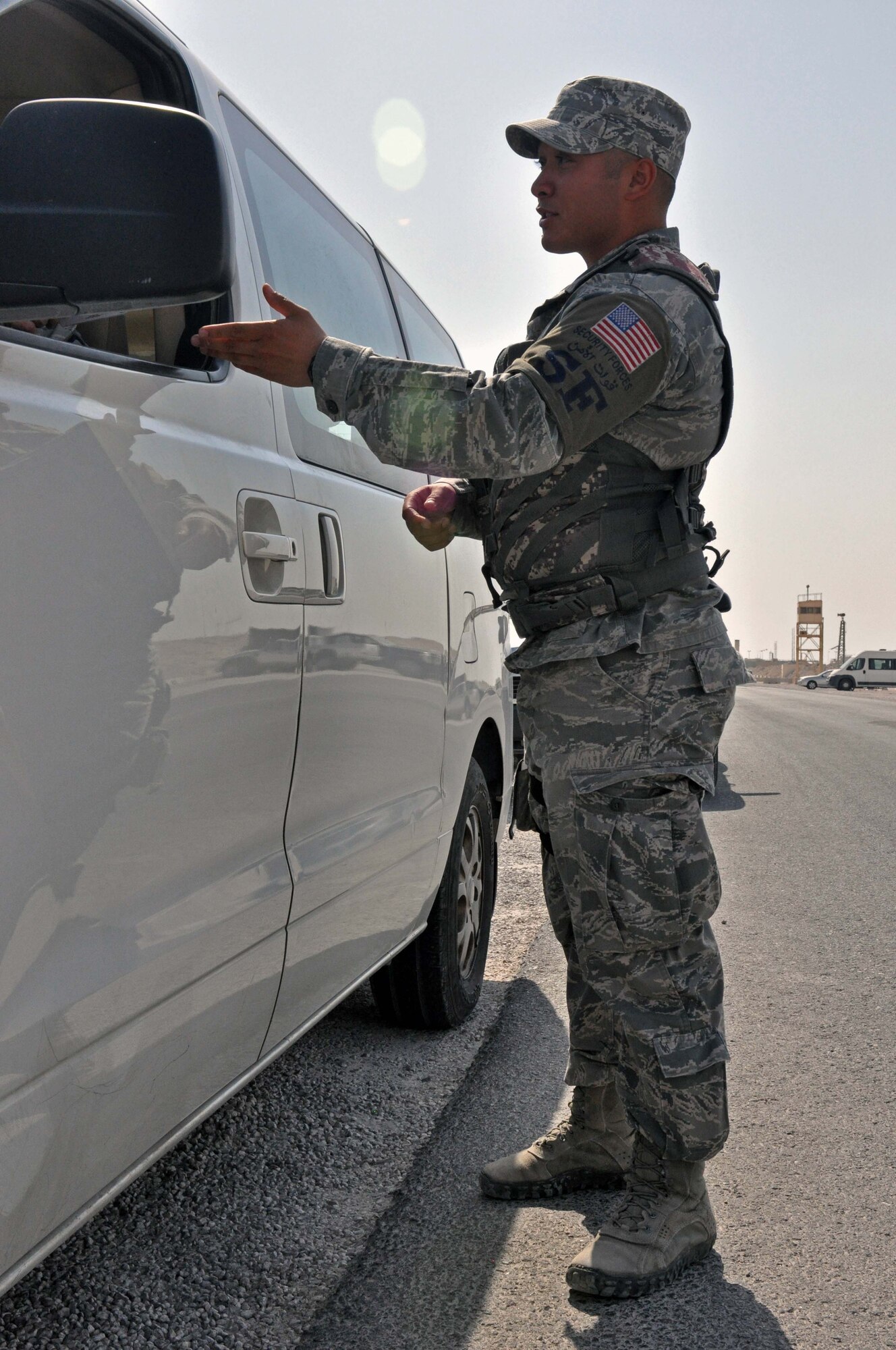 Senior Airman Joshua DeYoung explains a traffic violation to a driver at the 379th Air Expeditionary Wing in Southwest Asia, Oct. 1, 2013. DeYoung is a 379th Expeditionary Security Forces Squadron Airman assigned to Police One -- the law enforcement patrol. The 379th ESFS law enforcement program was implemented near the beginning of August to increase the safety and security of service members on base. DeYoung is deployed from Tinker Air Force Base, Okla., and a Dunkan, Okla., native. (U.S. Air Force photo/1st Lt. Susan Harrington)