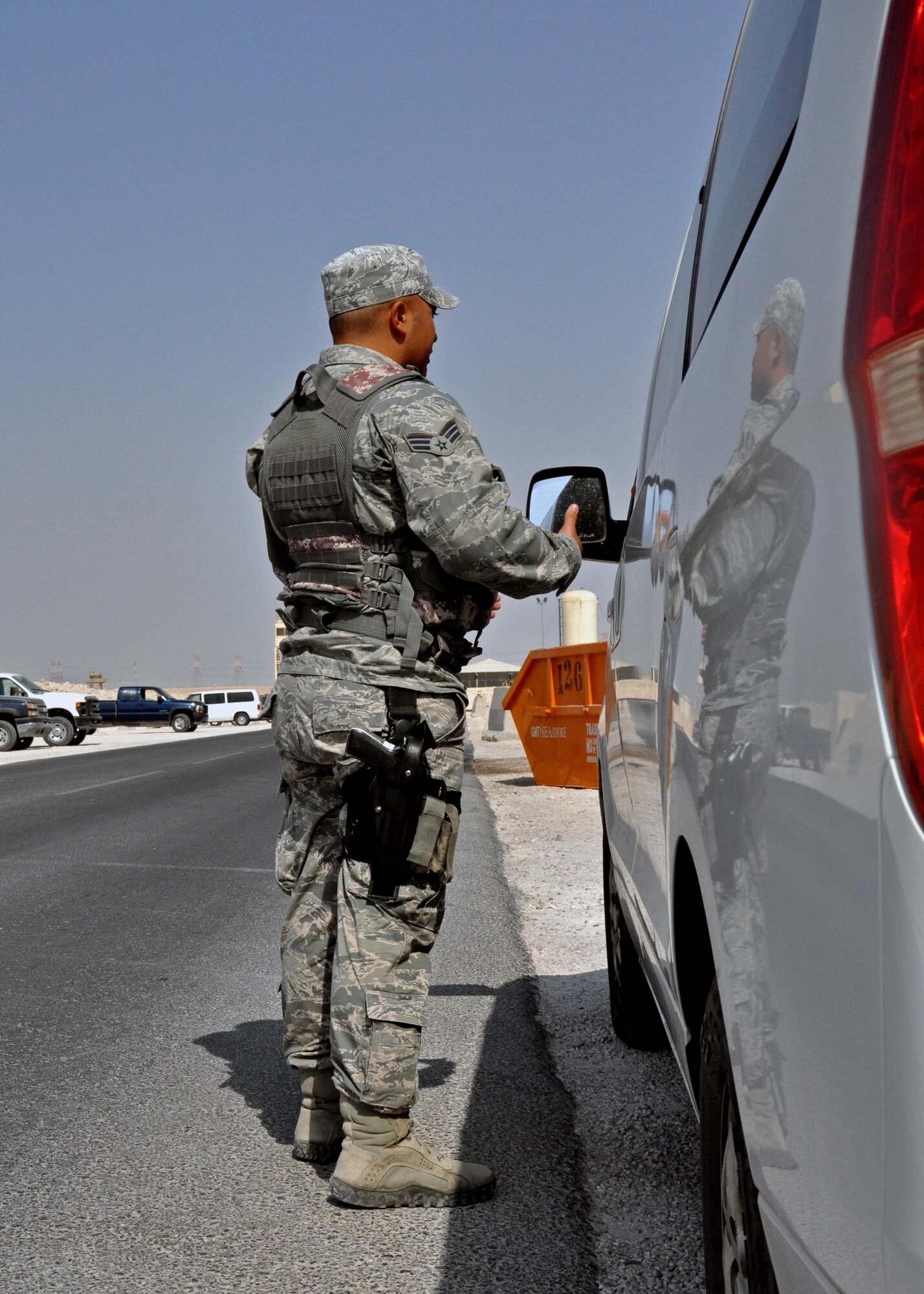 Senior Airman Joshua DeYoung explains a traffic violation to a driver at the 379th Air Expeditionary Wing in Southwest Asia, Oct. 1, 2013. DeYoung is a 379th Expeditionary Security Forces Squadron Airman assigned to Police One -- the law enforcement patrol. The 379th ESFS law enforcement program was implemented near the beginning of August to increase the safety and security of service members on base. DeYoung is deployed from Tinker Air Force Base, Okla., and a Dunkan, Okla., native. (U.S. Air Force photo/1st Lt. Susan Harrington)