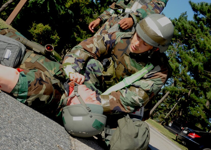 Senior Airman David Tierney, 8th Medical Operations Squadron, responds to an injured Airman during exercise Beverly Midnight 13-4 at Kunsan Air Base, Republic of Korea, Oct. 3, 2013. Exercises ensure the Wolf Pack medical staff is always prepared to respond in any situation. (U.S. Air Force photo by Staff Sgt. Jessica Haas/Released)
