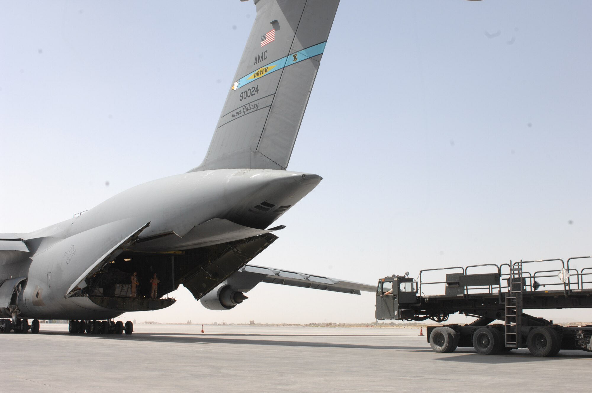 Airmen prepare to unload supplies and equipment from a C-5M Super Galaxy at Kandahar Airfield, Afghanistan, Sept. 19, 2013. Airmen from the 451st Expeditionary Logistics Readiness Squadron Aerial Port Flight move all kinds of cargo using military and civilian aircraft to supply U.S. and Coalition forces in Afghanistan. (U.S. Air Force photo story/ Senior Airman Jack Sanders)