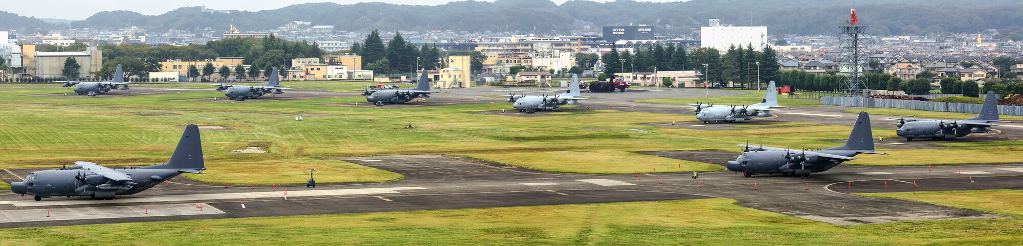 MC-130P Combat Shadow's and KC-130J Marine Super Hercules' park at Yokota Air Base, Japan, Oct. 4, 2013. Eighteen aircraft from Kadena Air Base and Marine Corps Air Station Futenma diverted to Yokota due to the inbound typhoon. (U.S. Air Force photo illustration by Osakabe Yasuo/Released) 