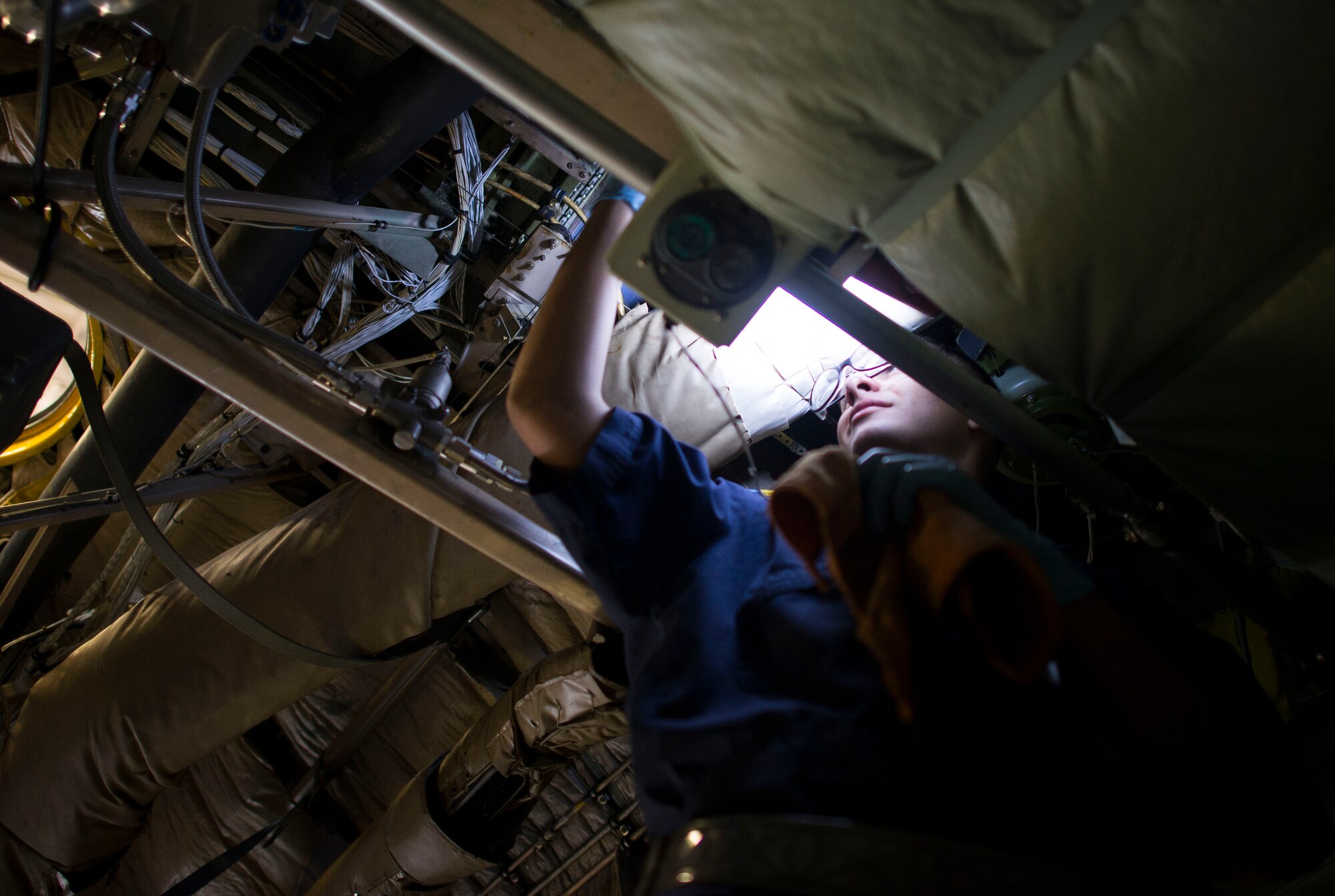 Airman 1st Class Jeffry Cardenas, 374th Maintenance Squadron Aerospace technician, conducts an isochronal inspection on a C-130 Hercules Oct. 4, 2013, at Yokota Air Base, Japan. Every 540 days an isochronal inspection is done on the aircraft to check its structures and perform operational checks. (U.S. Air Force photo by Staff Sgt. Chad C. Strohmeyer/released)
