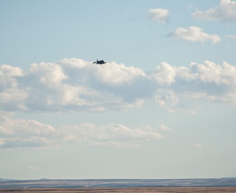 A U.S. Navy AV8-B Harrier buzzes a simulated enemy as a show of force, prior to returning and dropping a simulated bomb on target, Oct. 2, 2013, during exercise Mountain Roundup 2013. More than 300 Germans and Canadians, and an equal number of U.S. Navy, Marine Corps, Army and Air Force are participating in ground operations, close-air support, urban combatives, convoy operations, basic fighter maneuvers, counter air and multiple air-to-air training scenarios. (U.S. Air Force photo by Master Sgt. Kevin Wallace/RELEASED)