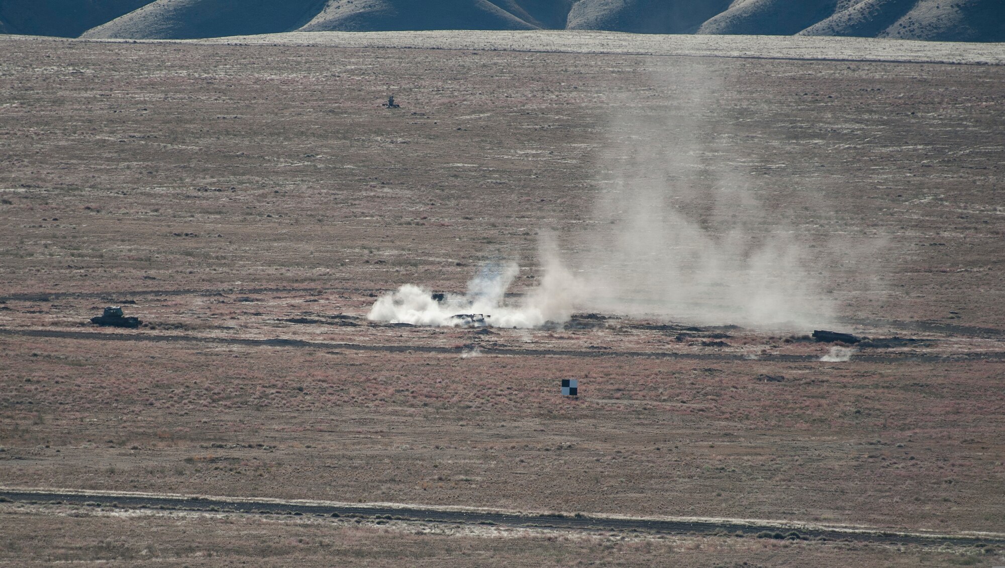 The ground erupts at Mountain Home Air Force Base, Idaho, Sailor Creek Range after a U.S. Navy AV8-B Harrier drops a simulated bomb on target, Oct. 2, 2013, during exercise Mountain Roundup 2013. The exercise is part of the German Air Force Tornado Fighter Weapons Instructor Course Mission Employment Phase. (U.S. Air Force photo by Master Sgt. Kevin Wallace/RELEASED)