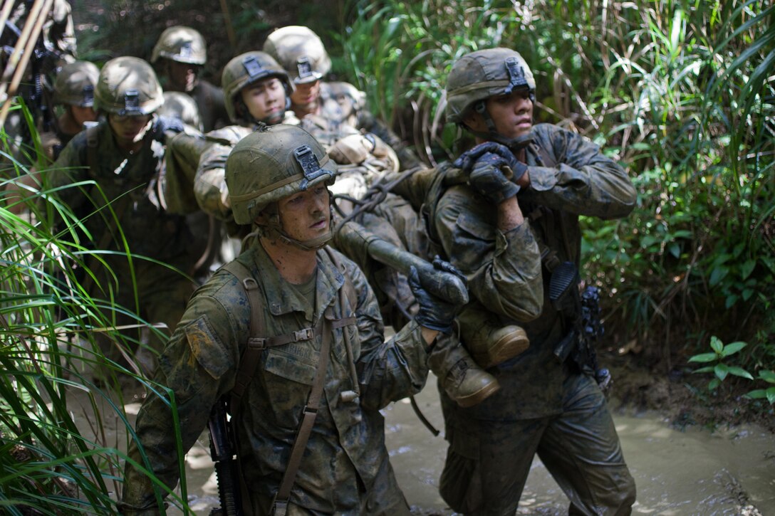 Marines with Company G., Battalion Landing Team 2nd Battalion, 4th Marines, 31st Marine Expeditionary Unit, carry a simulated casualty on an improvised stretcher during the culminating event of the Jungle Warfare Training Center’s jungle operations course here, Sept. 30. The Marines underwent a week of instruction in jungle warfare and survival skills. The culminating event tested the Marines in a jungle obstacle course spanning three miles through the Okinawan jungle. The 31st MEU is the only continuously forward-deployed MEU and is the Marine Corps’ force in readiness in the Asia-Pacific region.  