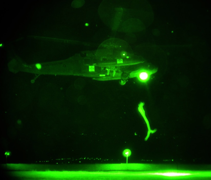 A UH-60 Blackhawk assigned to the 1-228th Aviation Regiment, Joint Task Force-Bravo, hovers over a landing zone at Soto Cano Air Base, Honduras, while the crewmembers conduct hoist training, Oct. 2, 2013.  The aircrew members of the 1-228th regularly conduct night-flying training missions in order to maintain proficiency and currency on flying while wearing night vision goggles (NGVS).  (U.S. Air Force photo by Capt. Zach Anderson)