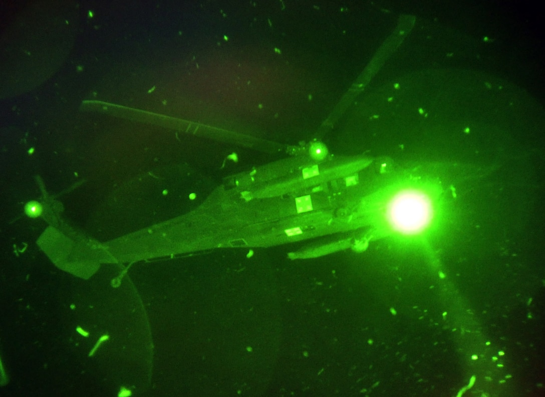 A UH-60 Blackhawk assigned to the 1-228th Aviation Regiment, Joint Task Force-Bravo, hovers over a landing zone at Soto Cano Air Base, Honduras, Oct. 2, 2013.  The aircrew members of the 1-228th regularly conduct night-flying training missions in order to maintain proficiency and currency on flying while wearing night vision goggles (NGVS).  (U.S. Air Force photo by Capt. Zach Anderson)