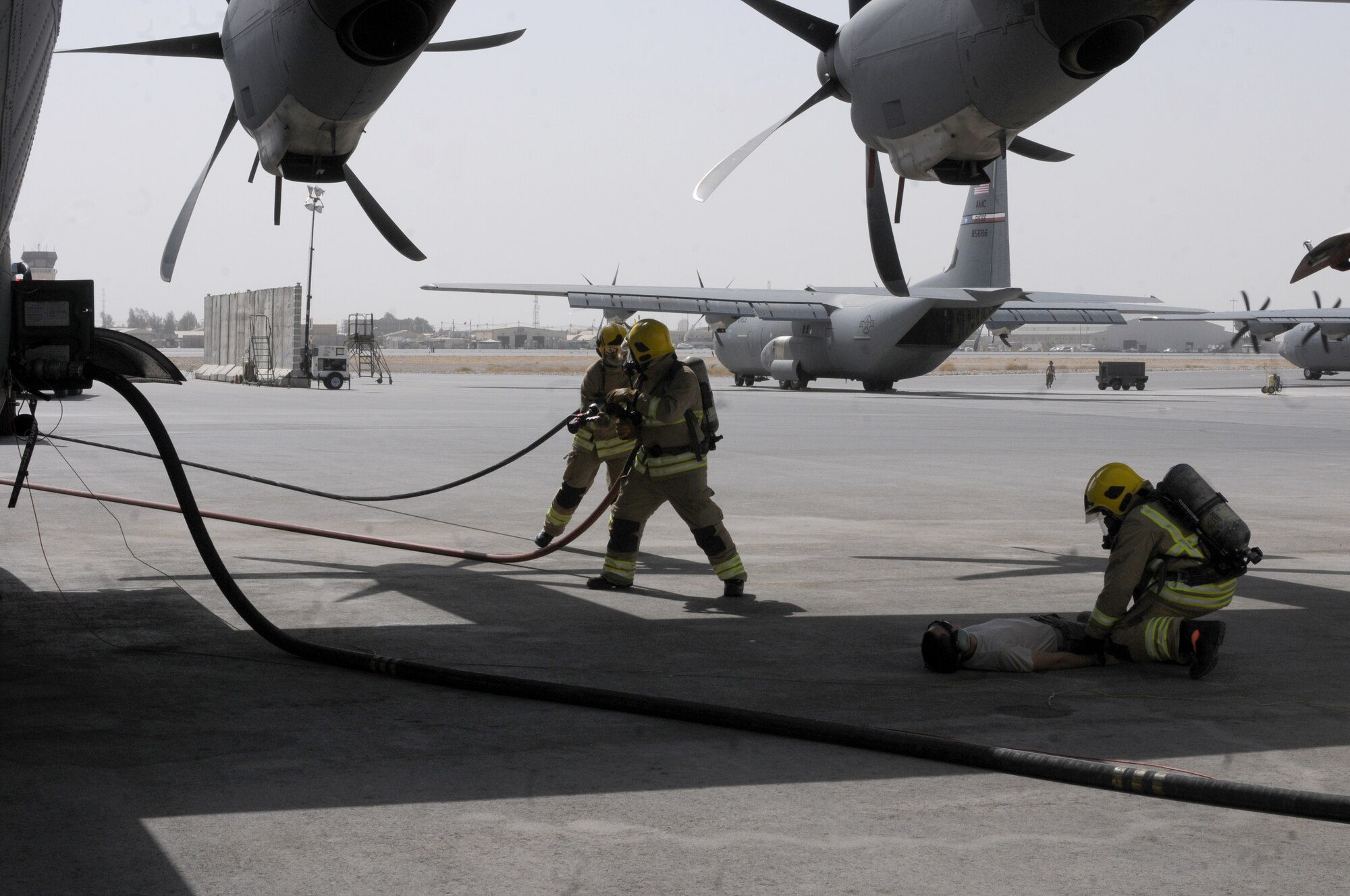 Members of the Kandahar Airfield Fire Department emergency fire response team train to address a large fire on an Air Force C-130J Hercules during fueling as part of a training exercise Sept. 28, 2013, at Kandahar Airfield, Afghanistan. Awareness and training exercises ensure emergency responders are prepared for any situation that could arise. “We hope nothing like this will ever happen, but we want to be prepared if it ever does,” said Steve Goodfellow, KAF Fire Department fire training and support officer. (U.S. Air Force photo by Senior Airman Jack Sanders)