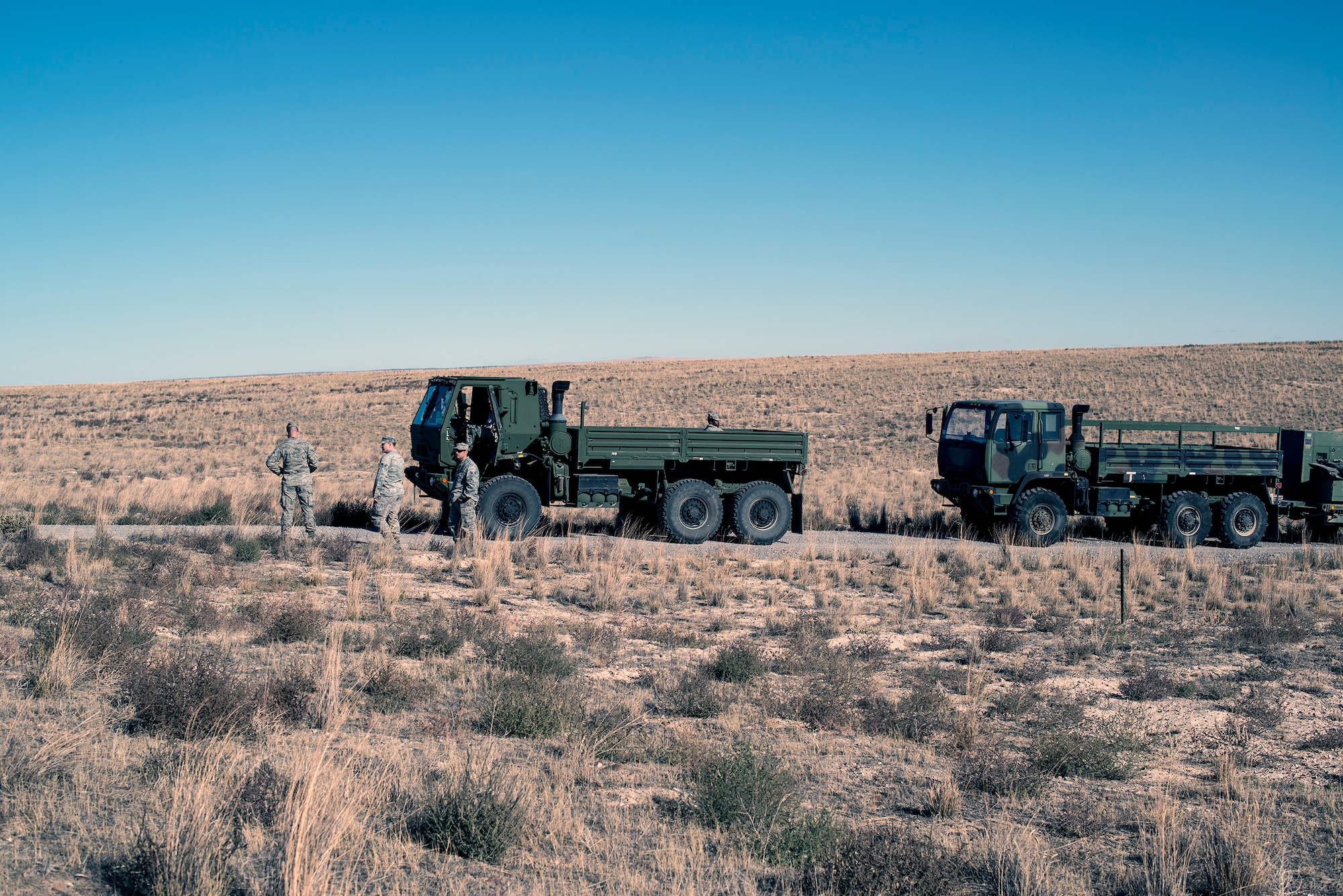 726th Air Control Squadron Airmen from Mountain Home Air Force Base, Idaho, take a quick break during a convoy halt in the Idaho desert roughly 75 miles from base Oct. 4, 2013. The 726th ACS convoy served as a training “enemy” force for U.S. Navy AV8-B Harriers, German Air Force AG-51 Tornados and for a team of U.S. Marine 1st Air Naval Gunfire Liaison Company joint terminal attack controllers, providing mutual beneficial training for all parties. (U.S. Air Force photo by Master Sgt. Kevin Wallace/RELEASED)