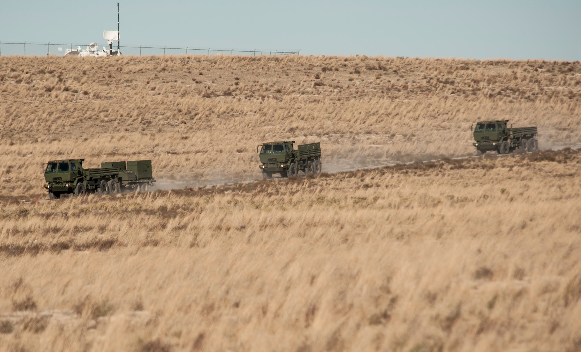 A 726th Air Control Squadron convoy moves across the Idaho desert, roughly 75 miles from Mountain Home Air Force Base, Oct. 4, 2013. The 726th ACS convoy served as a training “enemy” force for U.S. Navy AV8-B Harriers, German Air Force AG-51 Tornados and for a team of U.S. Marine 1st Air Naval Gunfire Liaison Company joint terminal attack controllers, providing mutual beneficial training for all parties. The 1st ANGLICO team members called in air support during the exercise to re-qualify JTACs and to maintain proficiency in their ability to provide close-air support, while training with another major coalition partner nation - Germany. The range complex is comprised of 7,400 square miles of associated airspace and 122,000 acres of land space used for two air-to-ground training ranges, five no-drop target complexes and 30 multi-size electronic combat sites. (U.S. Air Force photo by Master Sgt. Kevin Wallace/RELEASED)