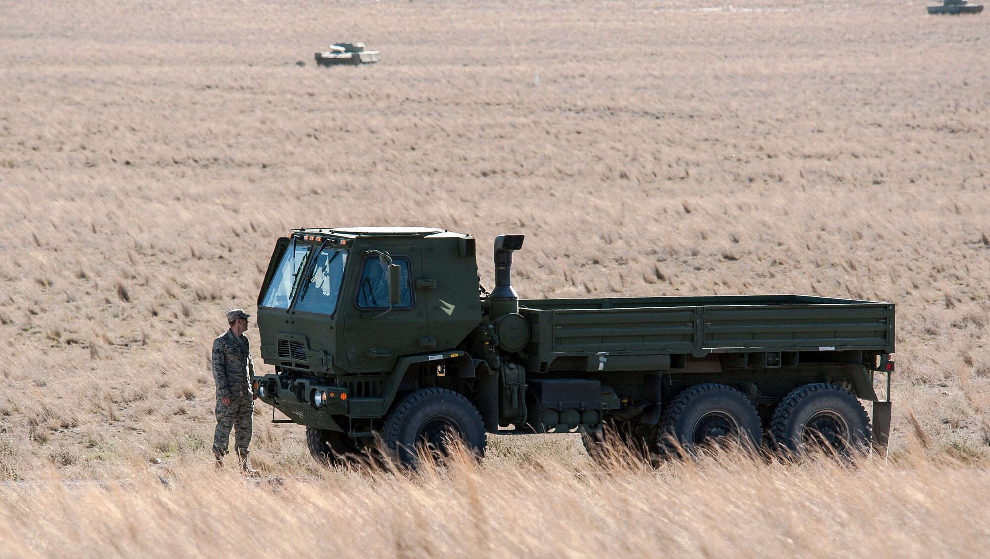 A 726th Air Control Squadron Airman from Mountain Home Air Force Base, Idaho, inspects his truck during a convoy halt in the Idaho desert roughly 75 miles from base Oct. 4, 2013. The 726th ACS convoy served as a training “enemy” force for U.S. Navy AV8-B Harriers, German Air Force AG-51 Tornados and for a team of U.S. Marine 1st Air Naval Gunfire Liaison Company joint terminal attack controllers, providing mutual beneficial training for all parties. (U.S. Air Force photo by Master Sgt. Kevin Wallace/RELEASED)