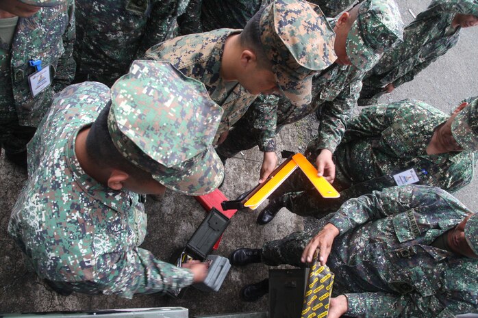 Philippines Marines explain the properties of their M-35 6x6 truck to U.S. Marine Sgt. Carlos A. Jimenez at Marine Barracks Rudiardo Brown, Fort Bonifacio, Tuguig City, Manila, Republic of the Philippines, Oct. 1 during Amphibious Landing Exercise 2014. Bilateral Philippine-U.S. Marine Corps training sustains and reinforces the foundation and framework for a bilateral force to respond rapidly and effectively to regional humanitarian crises. Jimenez is a motor transport operator with Combat Logistics Regiment 3, 3rd Marine Logistics Group, III Marine Expeditionary Force, which is currently part of the logistics combat element for 3d Marine Expeditionary Brigade, III MEF. The Philippine Marines are with Motor Transport and Maintenance Battalion, Combat Service Support Brigade, Philippine Marine Corps.