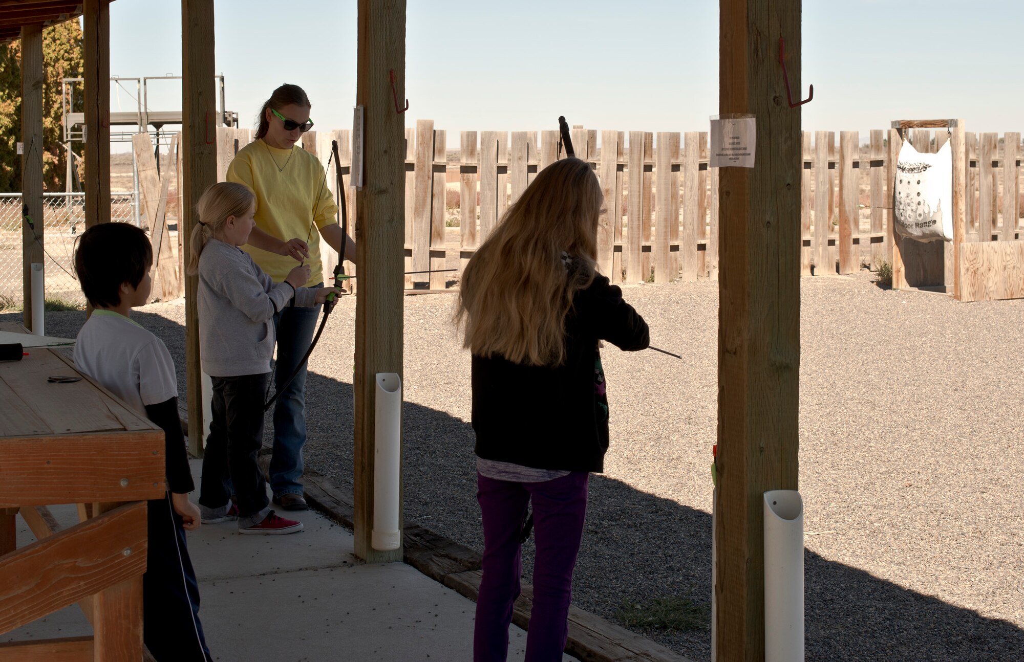 Mountain Home Air Force Base elementary and middle-school aged children practice shooting longbows during the first portion of a youth center archery class at the base archery range, Oct. 5, 2013. In all, seven children to learn to shoot long bows, compound bows and recurve bows during the three-hour course. (U.S. Air Force photo by Master Sgt. Kevin Wallace/RELEASED)