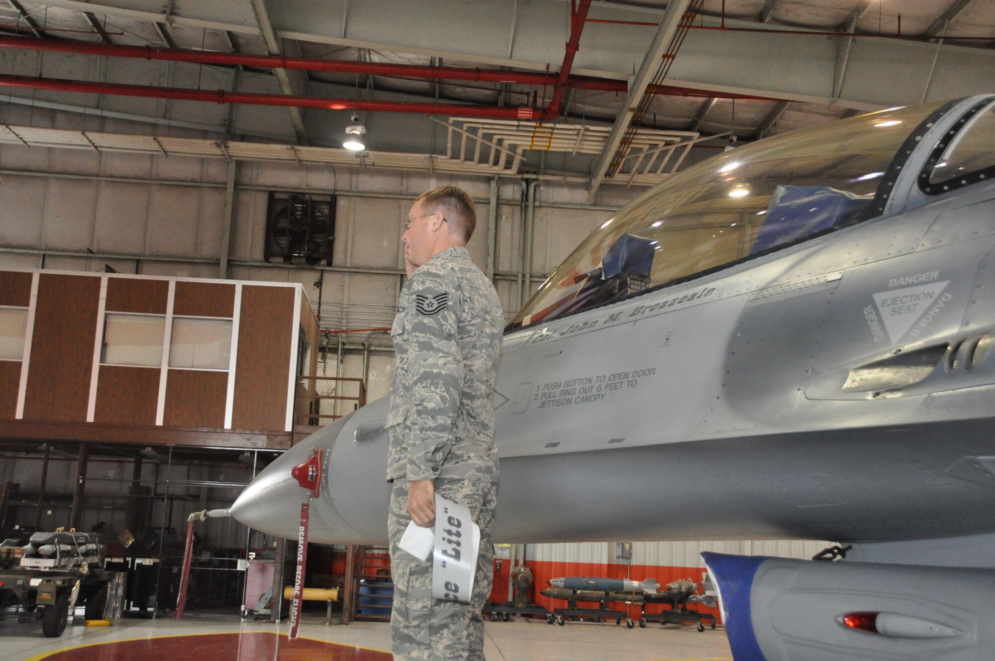 The new 301st Fighter Wing commander, Col. John Breazeale, speaks to the troops during his Change of Command ceremony Oct. 5 at Naval Air Station Fort Worth Joint Reserve Base, Texas, while CMSgt Brian Pinsky, 301st FW's Command Chief Master Sergeant, looks on. Maj. Gen. William Binger, 10th Air Force commander, presided over the ceremony. (U.S. Air Force photo/MSgt Julie Briden-Garcia)