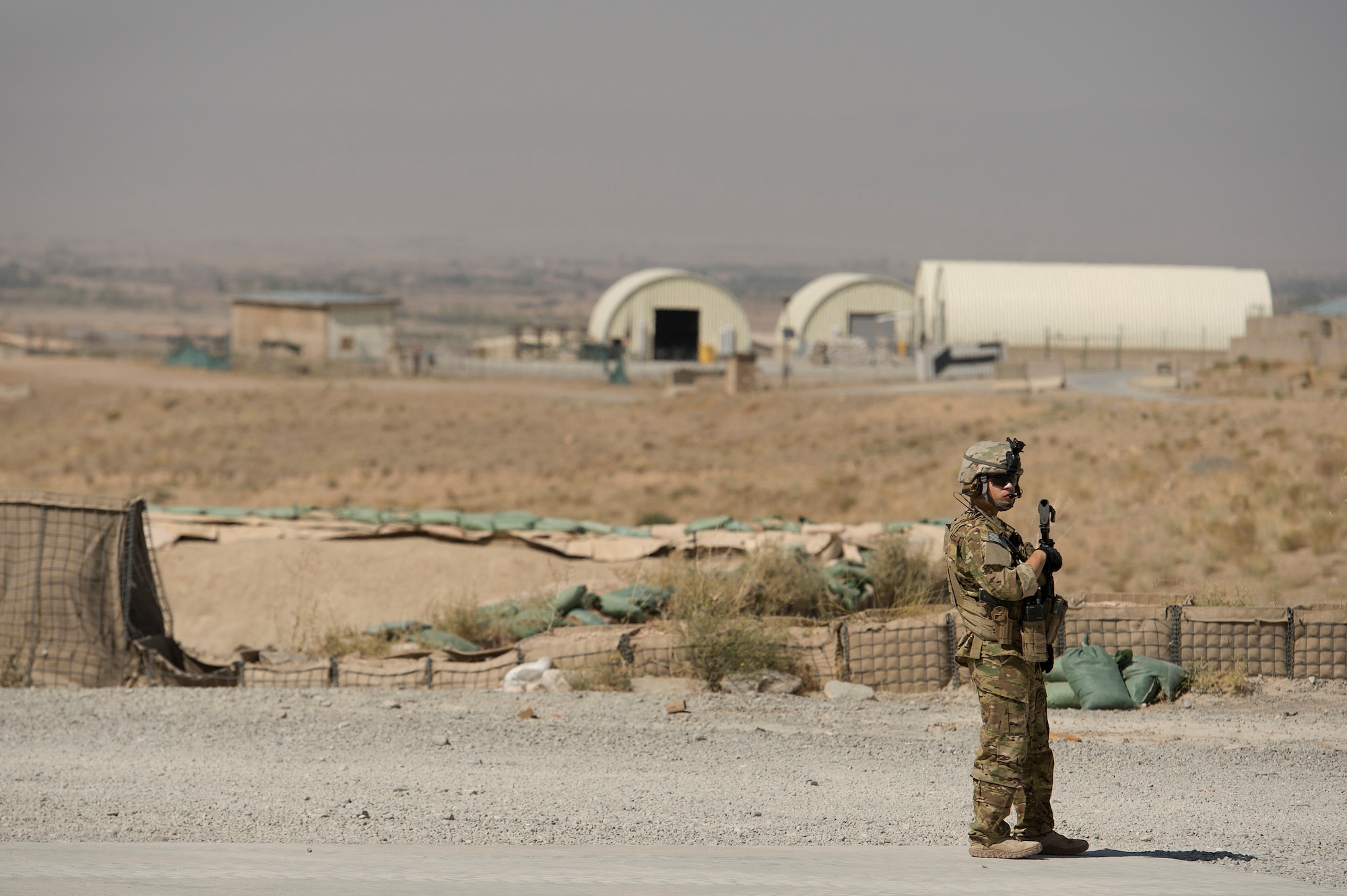 Staff Sgt. Juan Pareja, 455th Expeditionary Security Forces Squadron Fly-Away Security Team airman, provides security as 774th Expeditionary Airlift Squadron C-130 Hercules loadmasters move the last portion of cargo from Forward Operating Base Sharana, Paktika province, Afghanistan, Sept. 28, 2013. This mission marked a retrograde milestone as the 774th EAS transported the last cargo from FOB Sharana before the base is transferred to the Afghan Ministry of Defense. Pareja, a White Planes, N.Y, native, is deployed from Davis-Montham Air Force Base, Ariz.
(USAF Photo/Master Sgt. Ben Bloker)